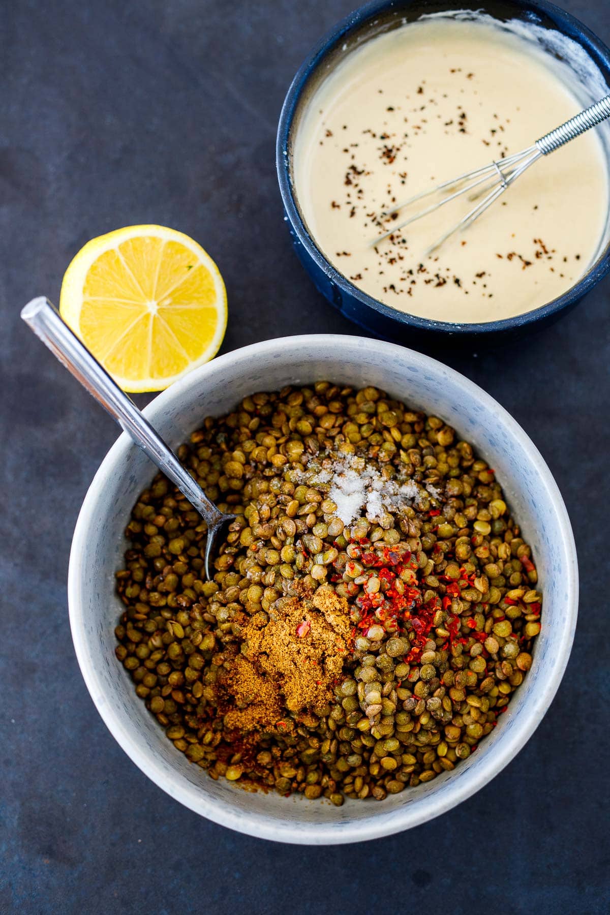 seasoning the lentils and a bowl of tahini sauce. 