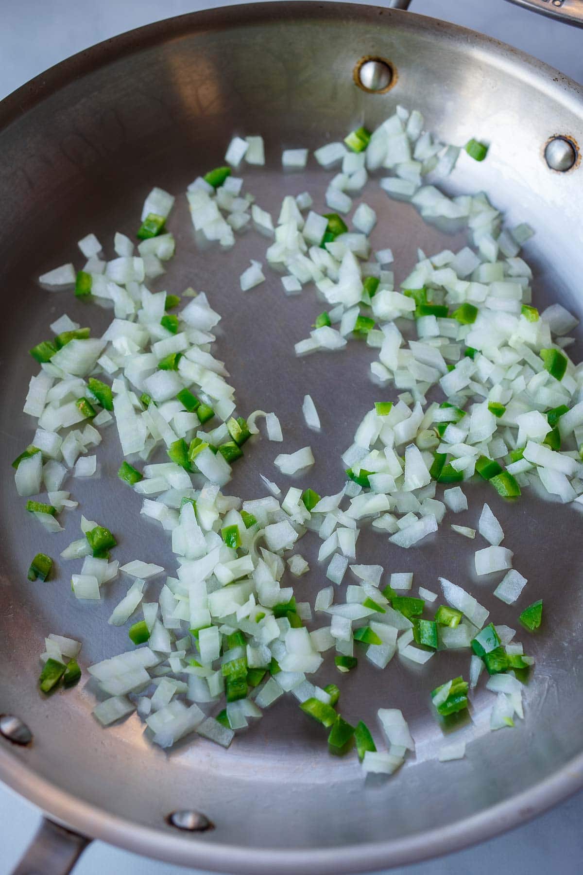 diced onions and jalapeno in skillet sauteing.
