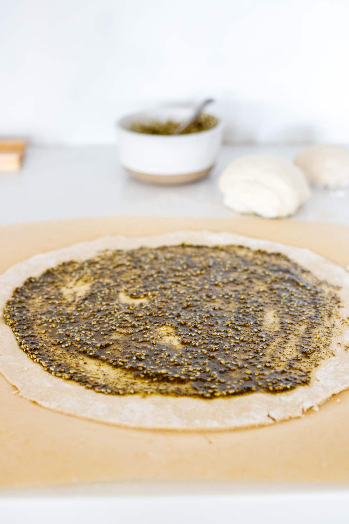 zaatar paste spread onto manoushe.