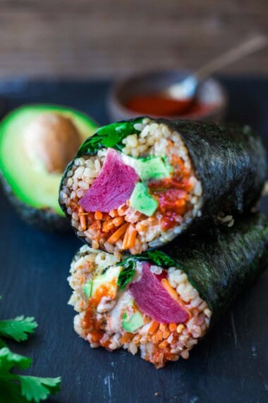 A sushi burrito with ahi tuna, avocado and rice, rolled up in nori.