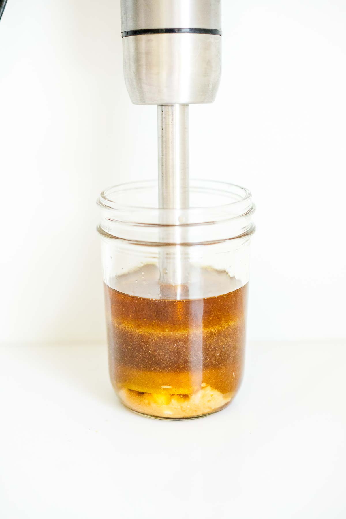 immersion blender in jar with ginger wasabi dressing. 