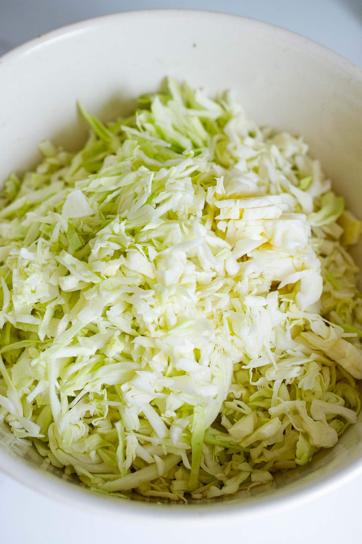 shredded green cabbage in bowl. 