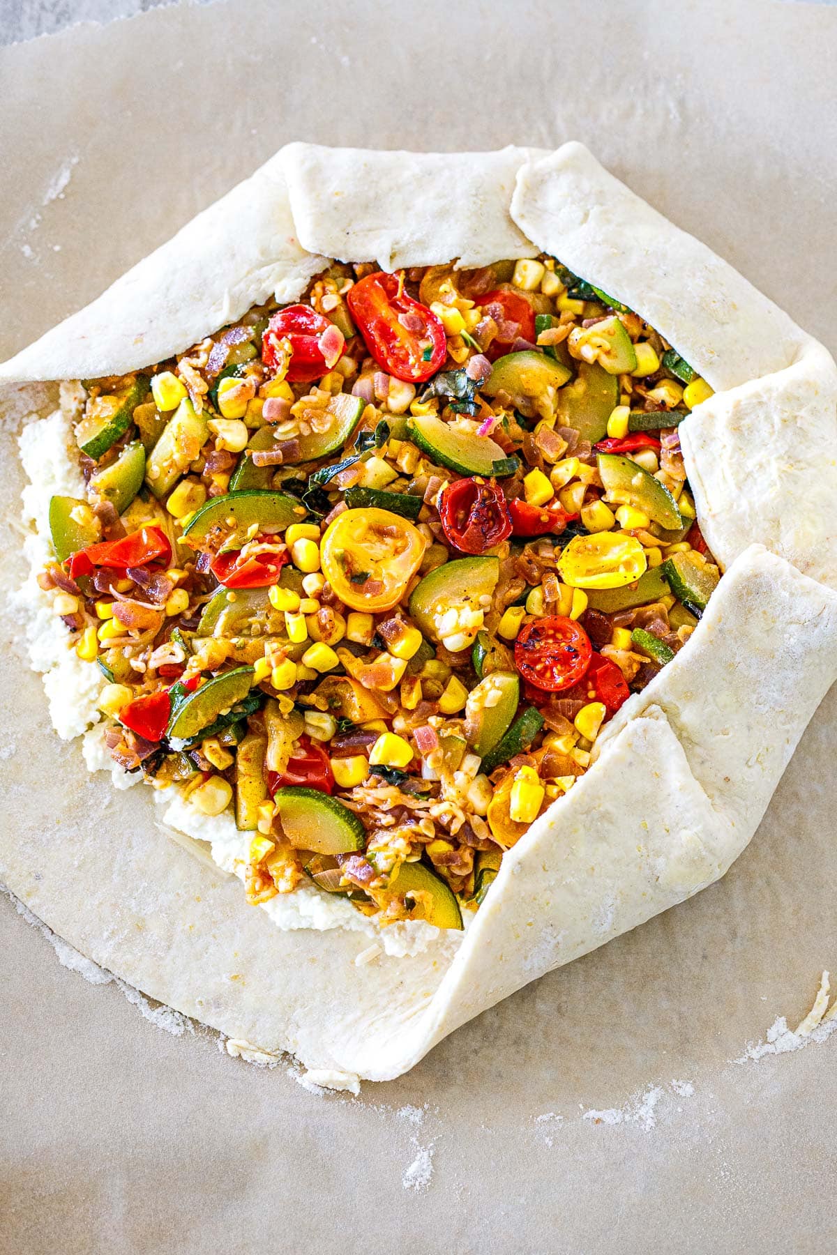unbaked galette with edges partially folded over top. 