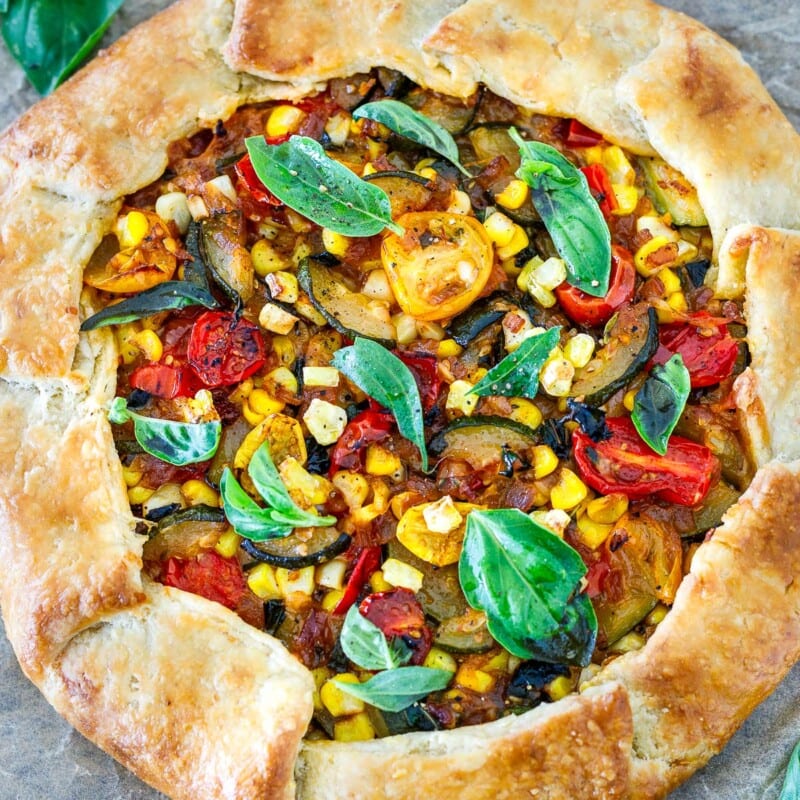 This savory galette is filled with summer tomatoes, corn, and zucchini, with ricotta, basil and parmesan baked in a free-form pie crust until beautifully golden. Allow 1 hour refrigeration time. 