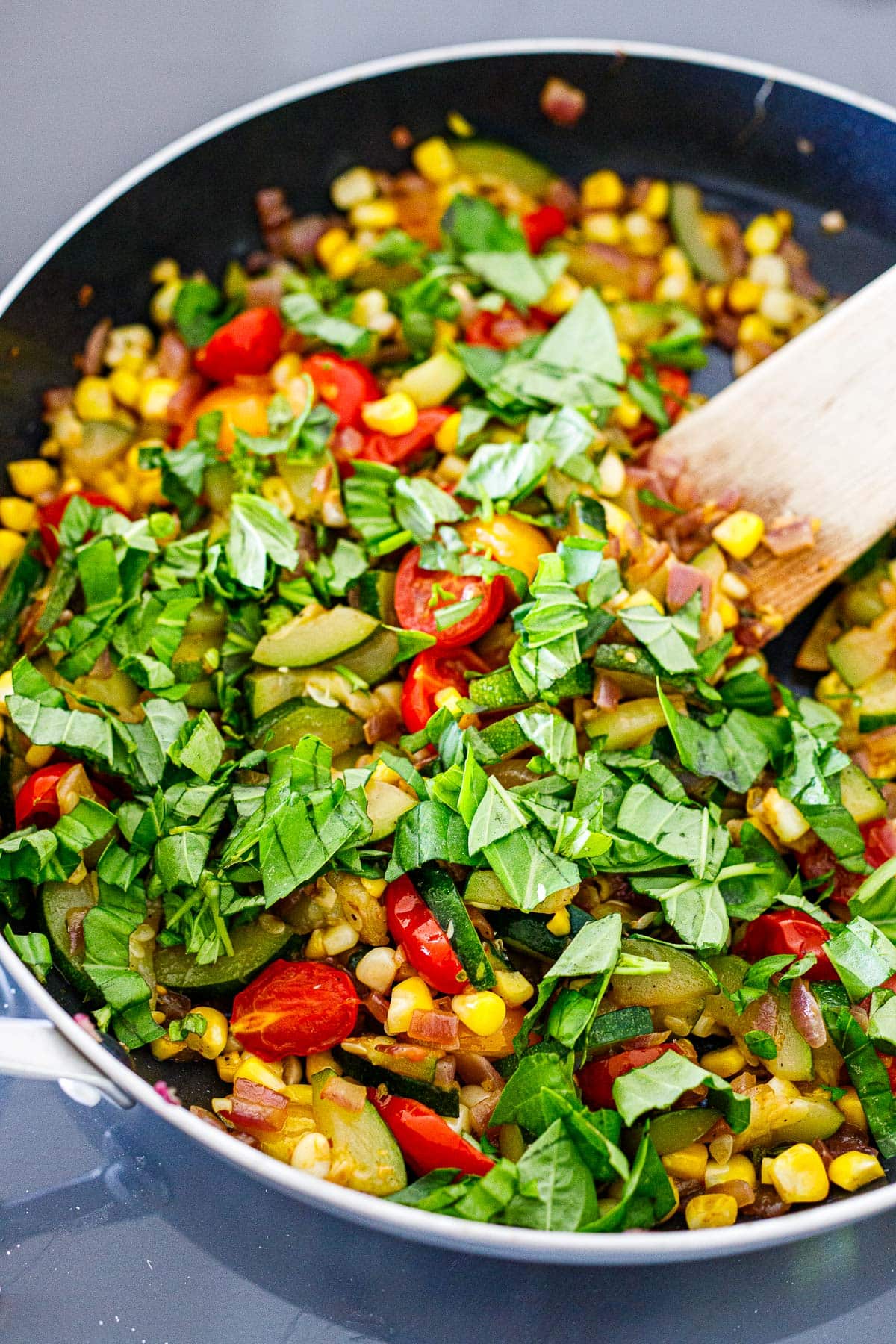 skillet with veggie filling for the galette- sauteed zucchini, onion, corn, cherry tomatoes, and fresh basil. 