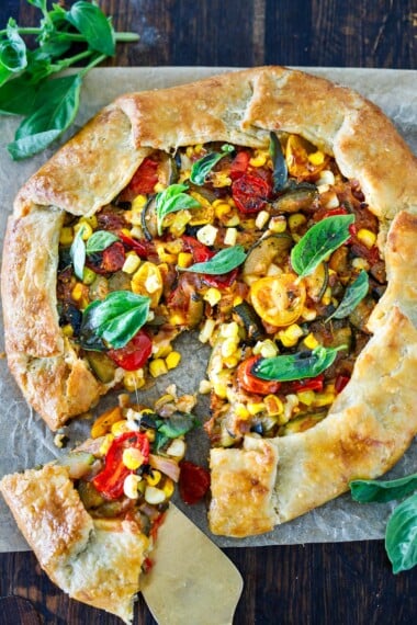 This savory galette is filled with summer tomatoes, corn, and zucchini, with ricotta, basil and parmesan baked in a free-form pie crust until beautifully golden. Allow 1 hour refrigeration time. 