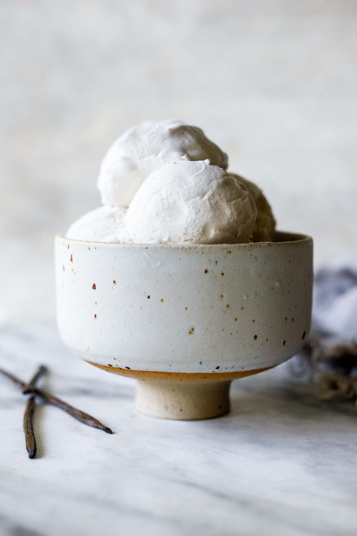 ceramic bowl with scoops of dairy-free ice cream piled high. 