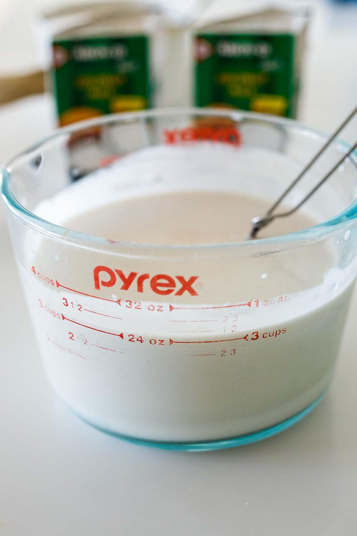 glass measuring cup with coconut milk ice cream base.