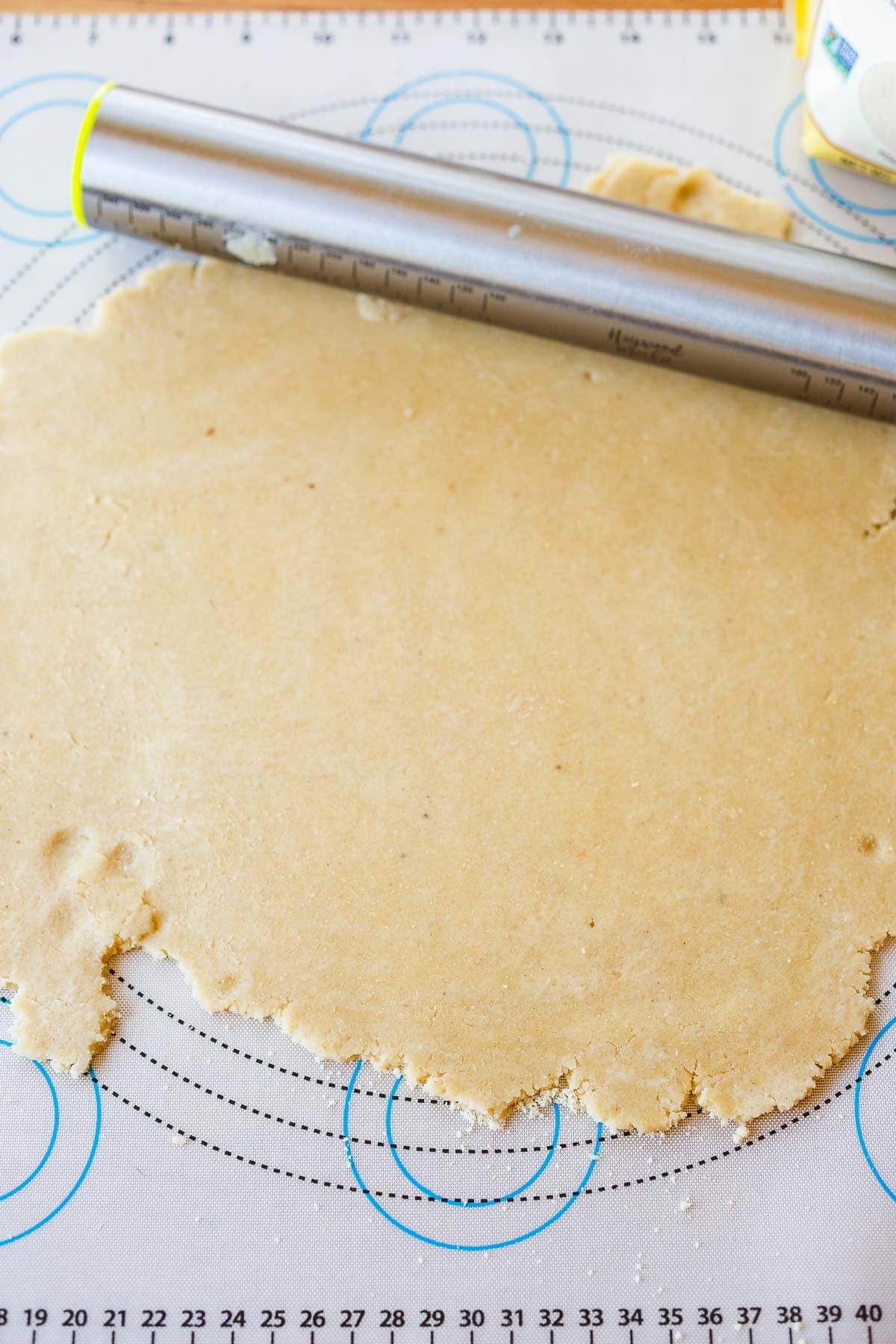 rolling pin rolling out tart dough into even layer.