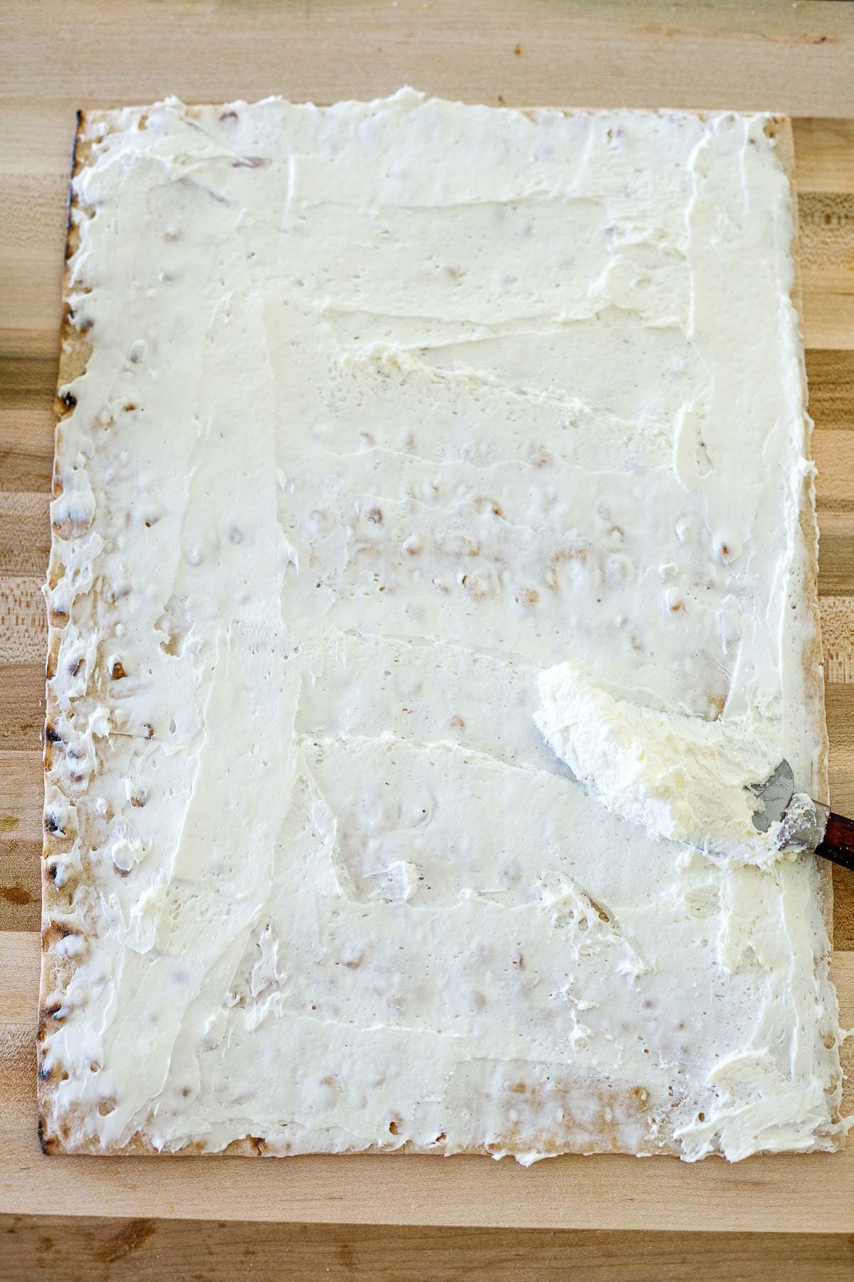 lavash bread with cream cheese spread out across top. 