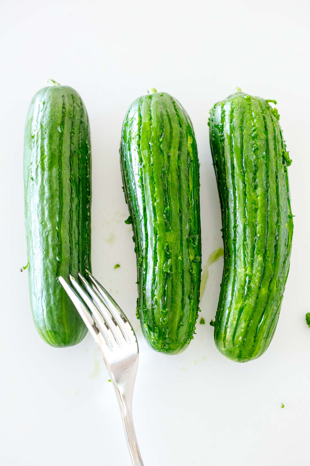 fork scoring the cucumbers. 