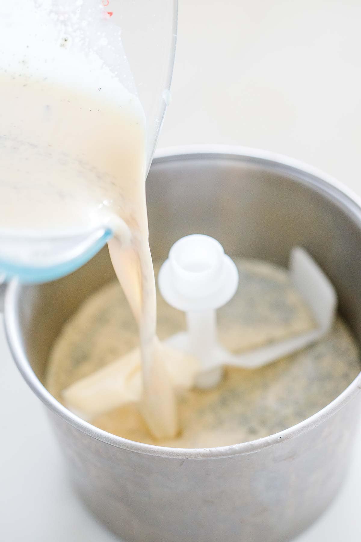 pouring vanilla base into ice cream maker.