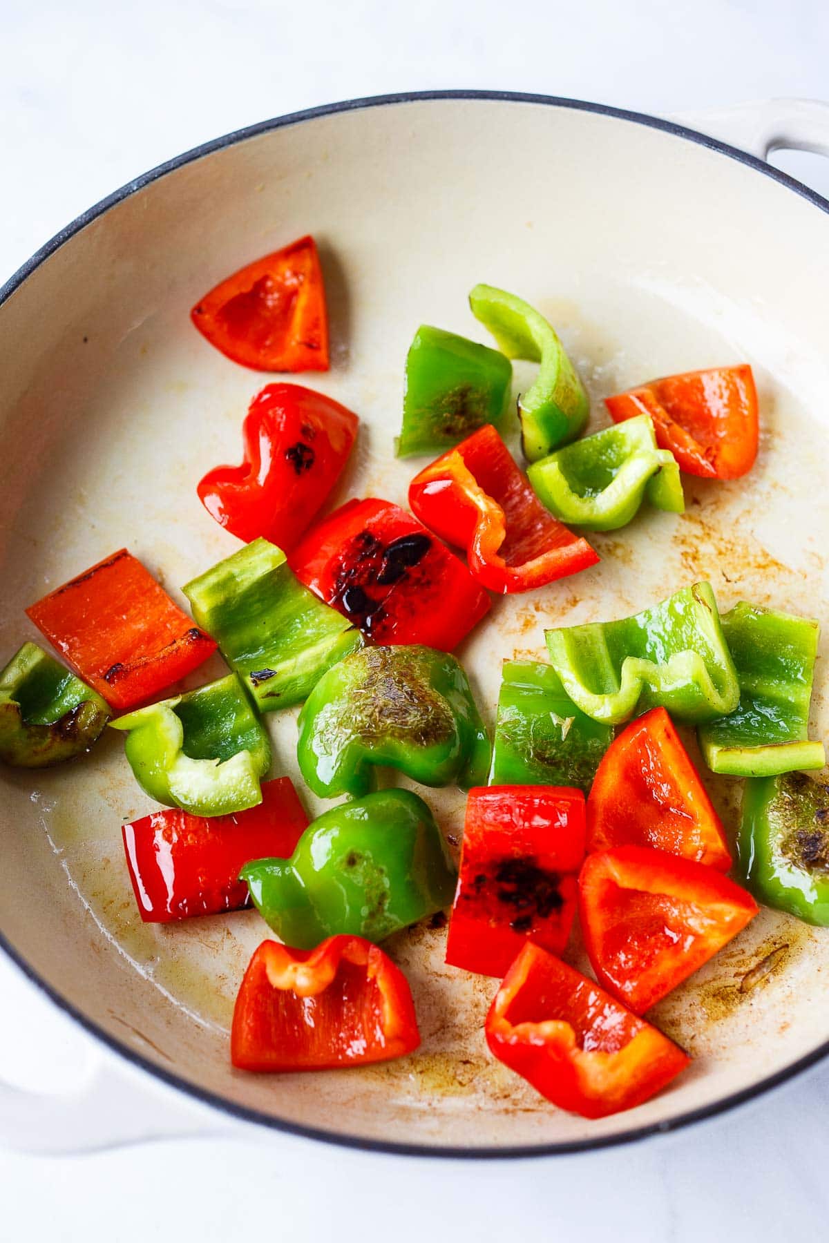 chopped peppers sautéing in pan. 