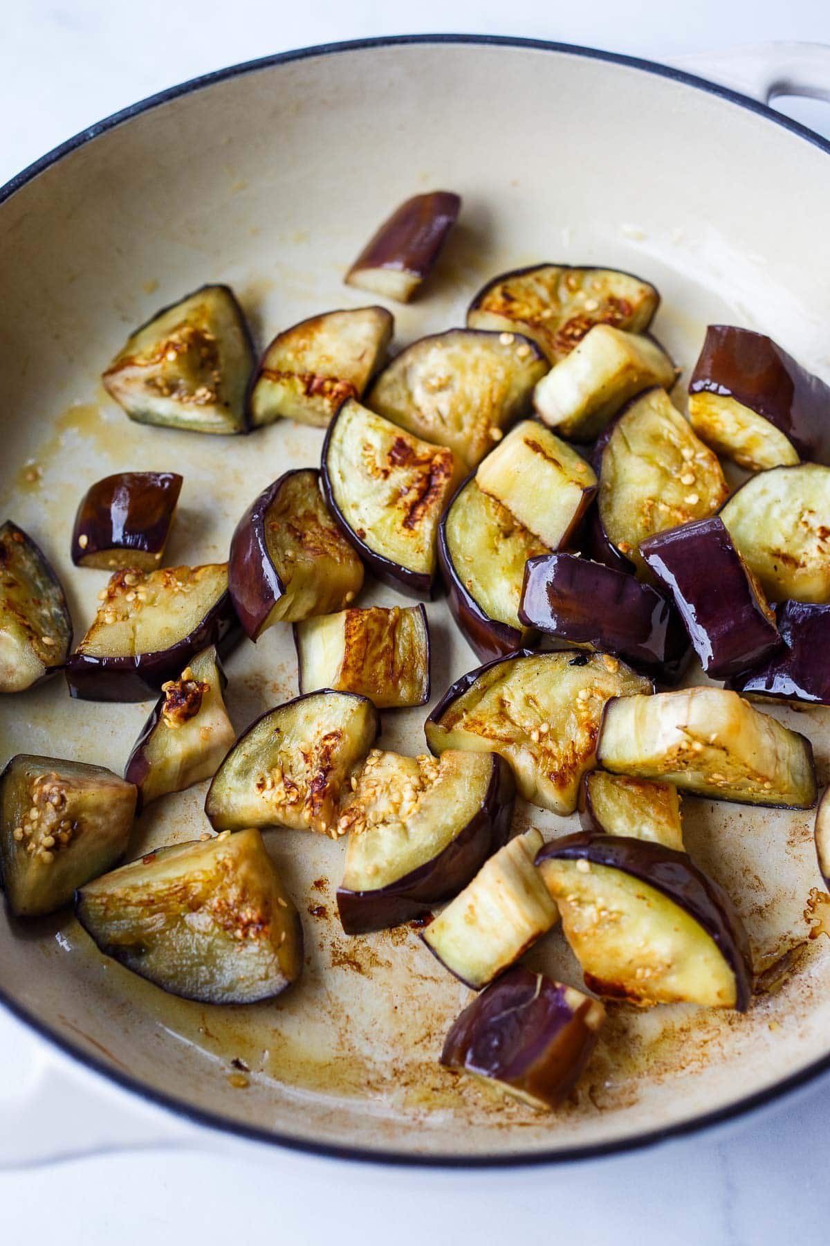 chopped eggplant browning in pan.
