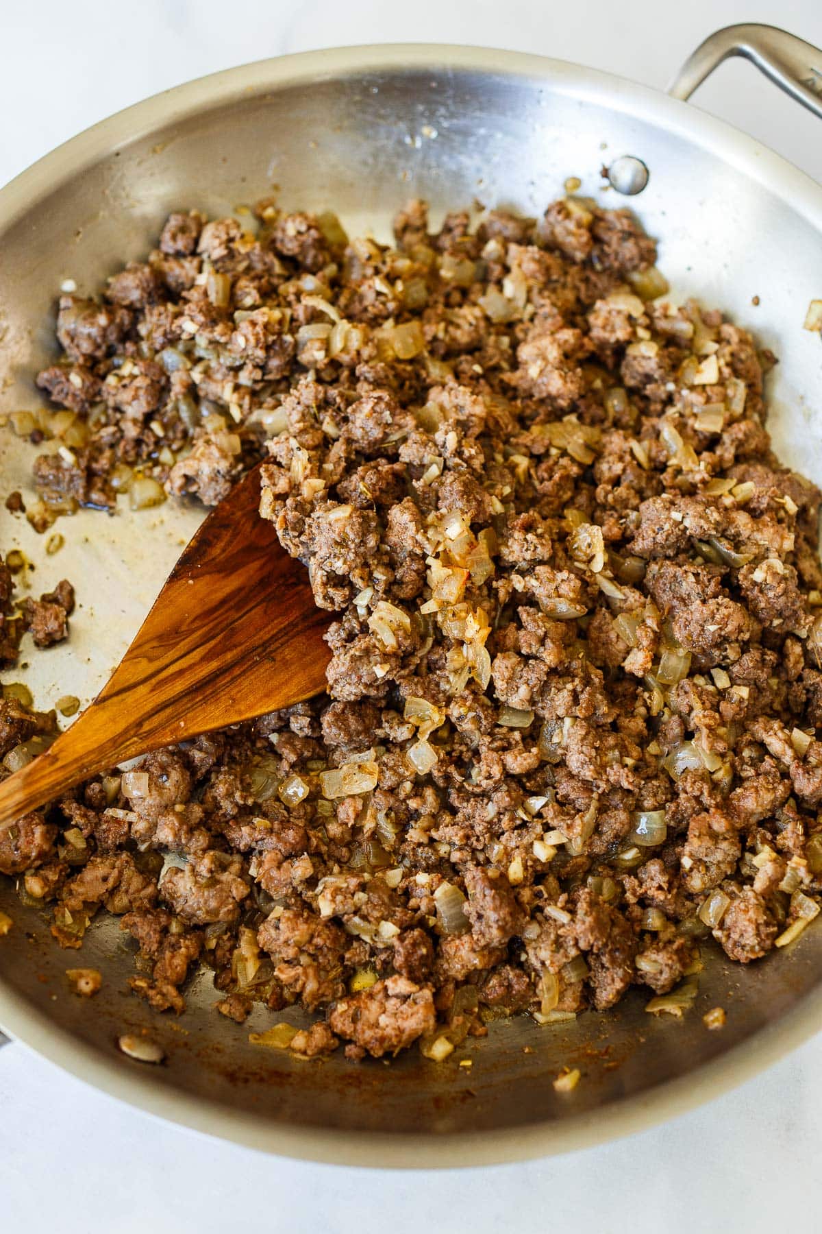 skillet with cooked Italian sausage.