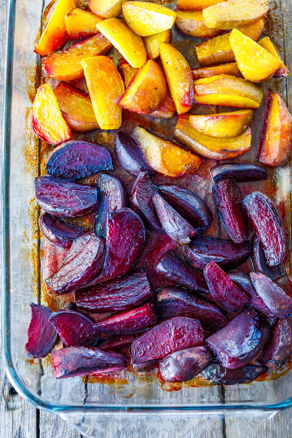 glass baking dish with roasted red beets and gold beets.