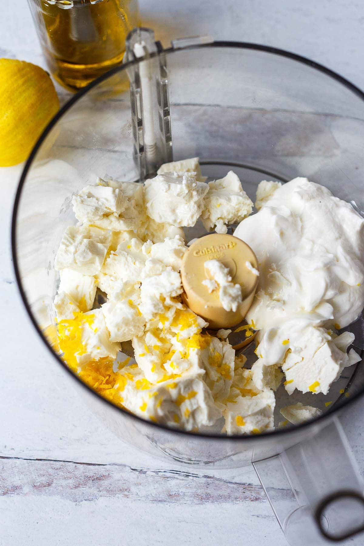 greek yogurt, feta, and lemon zest in bowl of food processor.