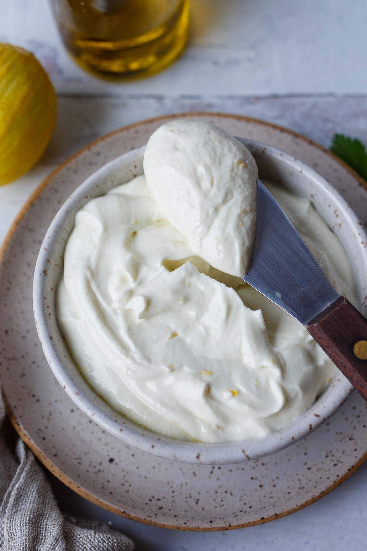 knife spreading whipped feta into serving dish.