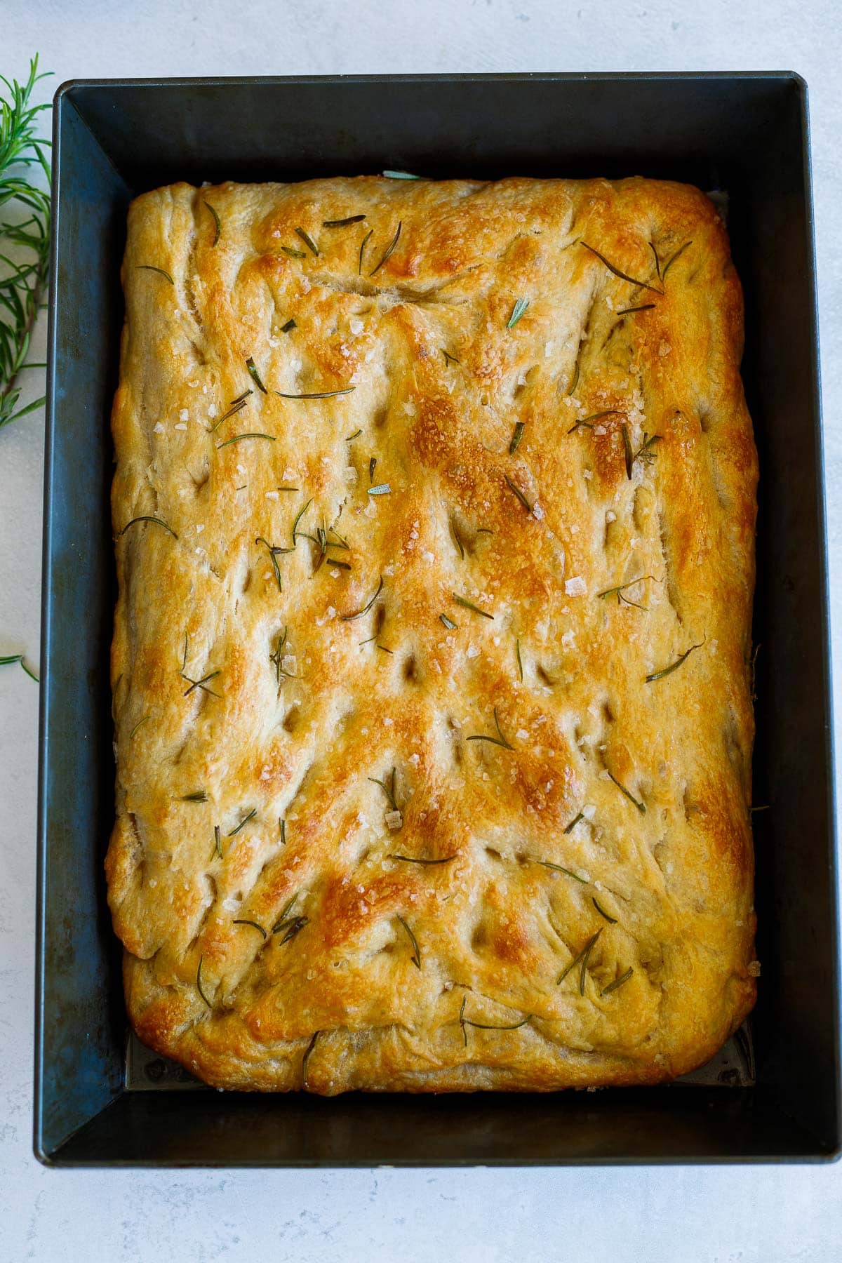 baked rosemary focaccia in pan.
