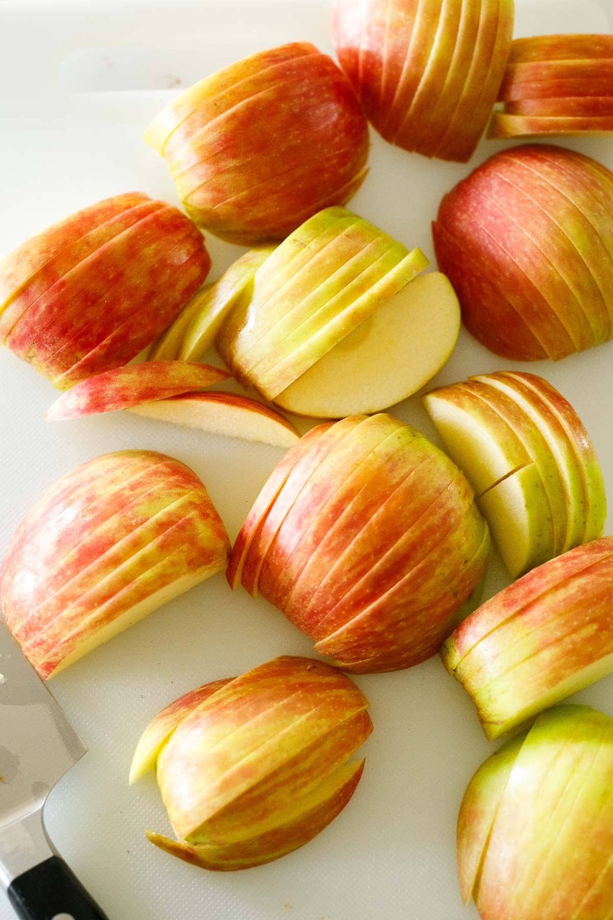 sliced honeycrisp apples on cutting board. 