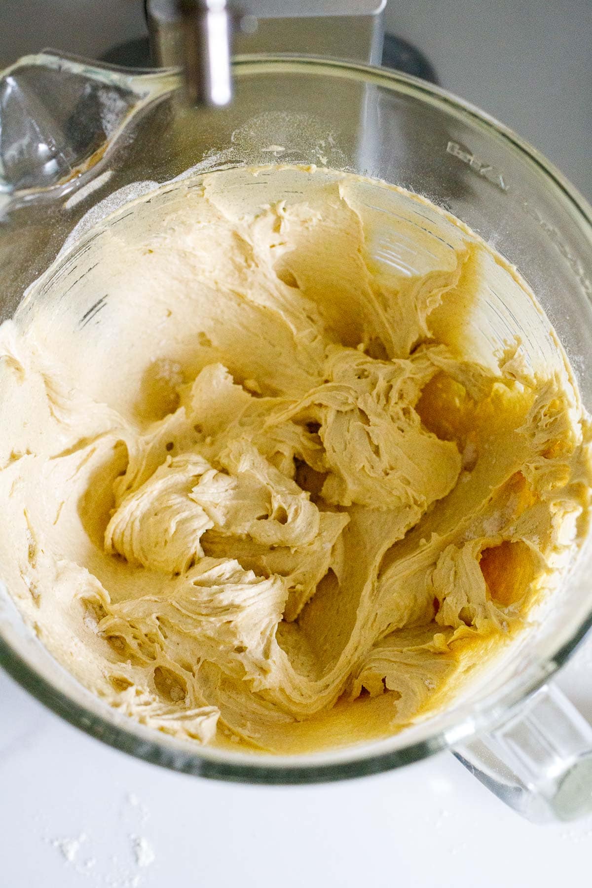 bowl of stand mixer with apple cake batter. 