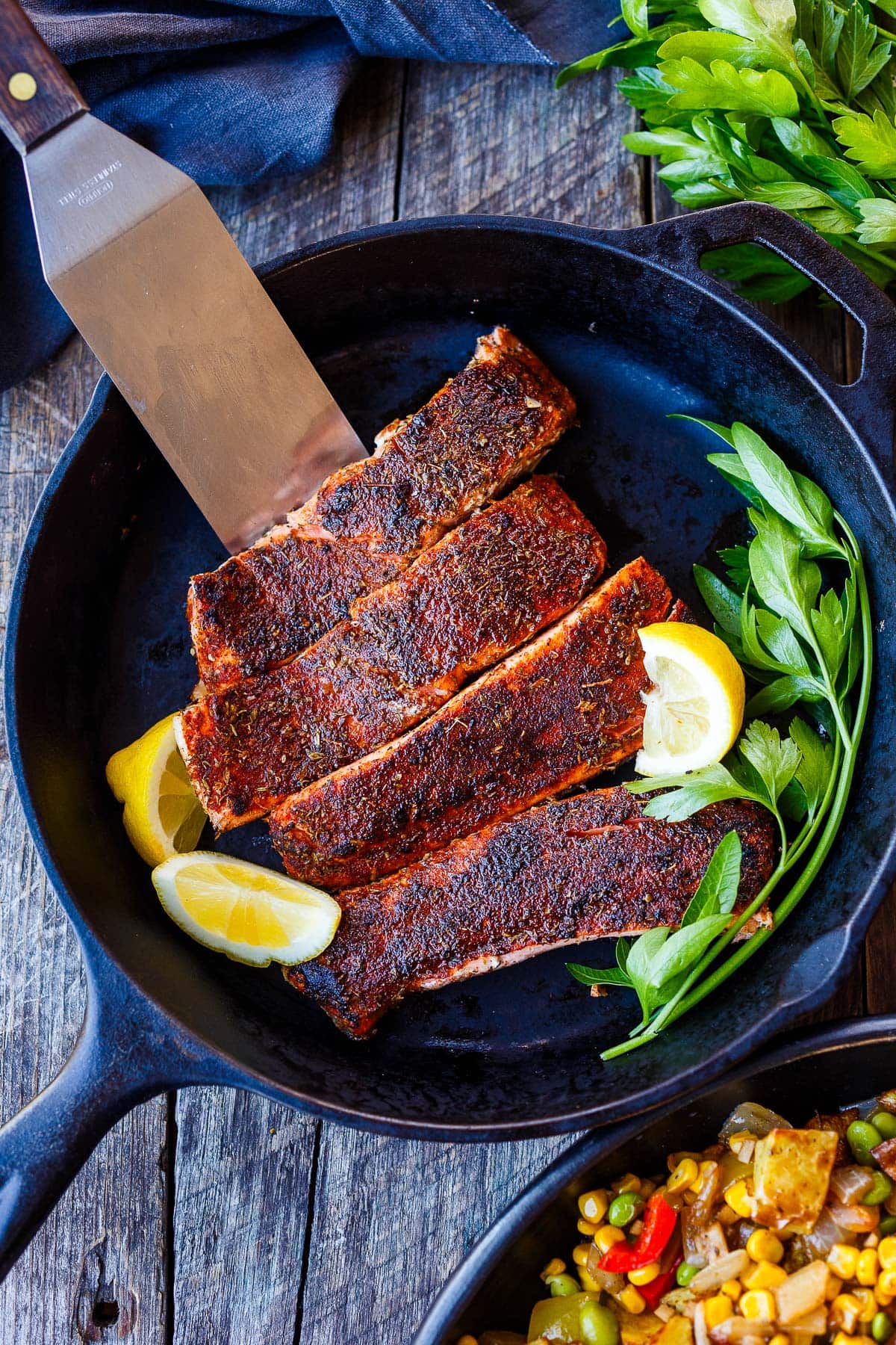 Salmon filets seared in a cast iron pan.