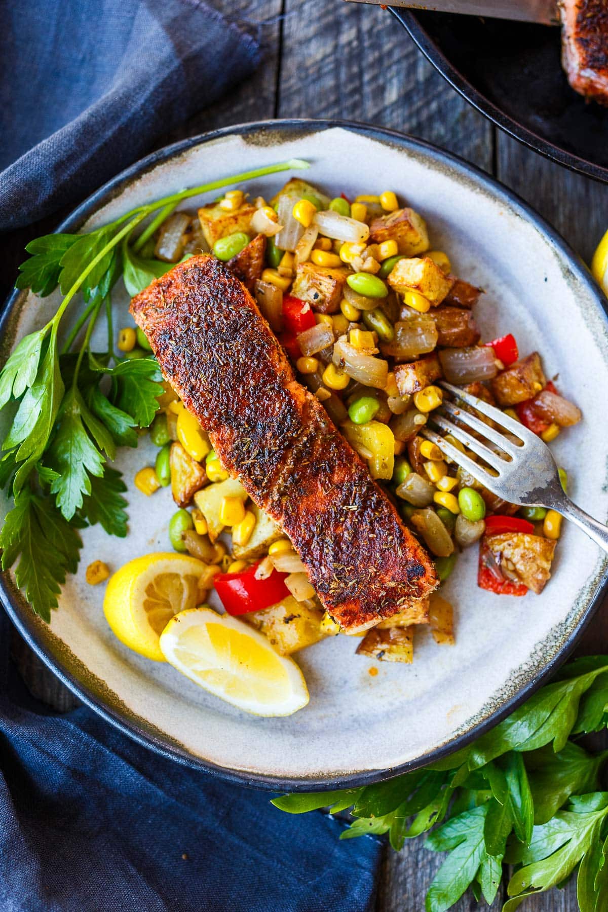 blackened salmon served over succotash.