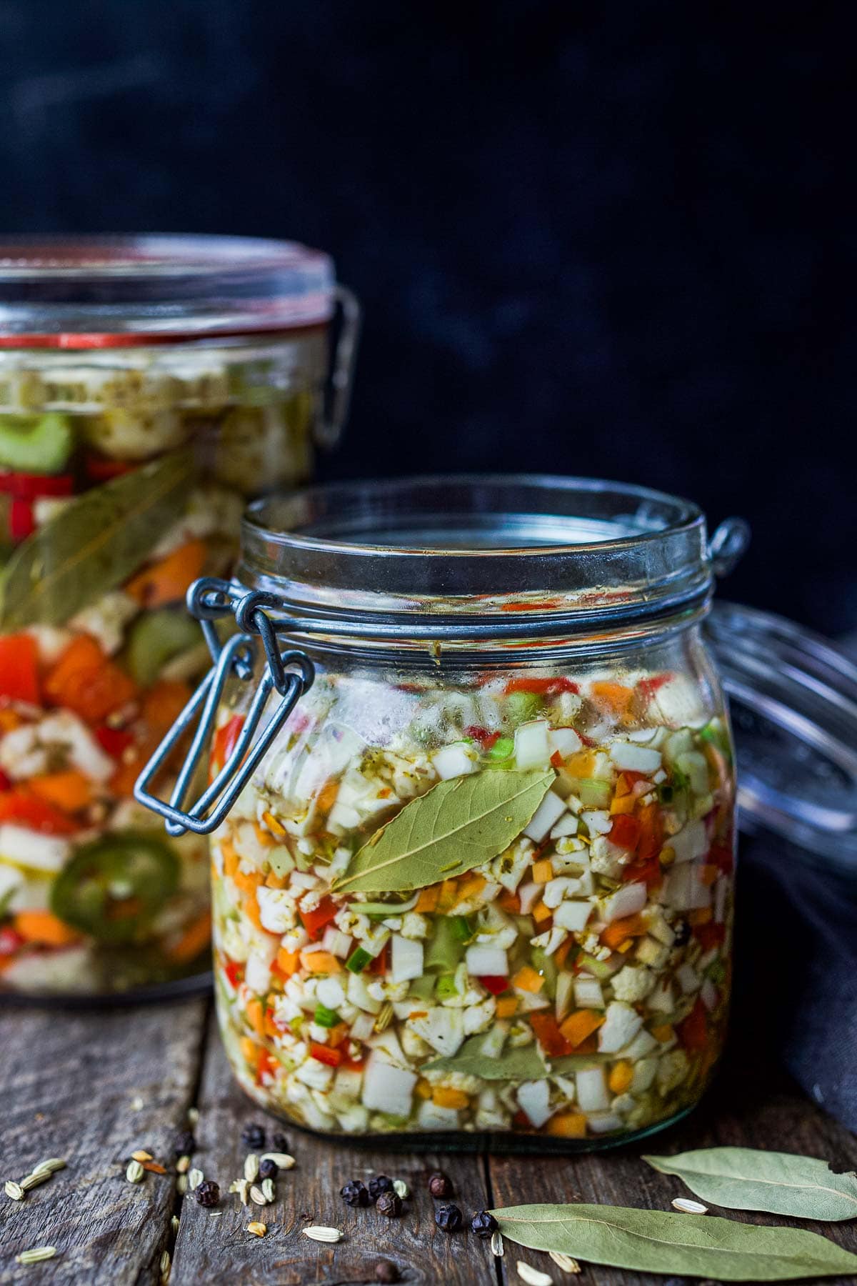 glass jar with giardiniera that is finely diced as a relish with bay leaf. 
