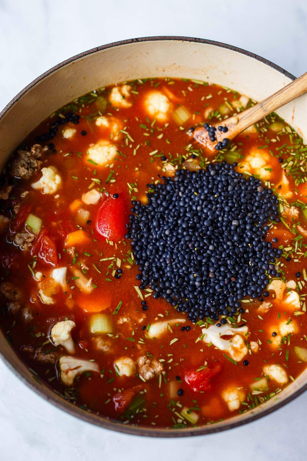 large pot of turkey sausage soup with black caviar lentils added.