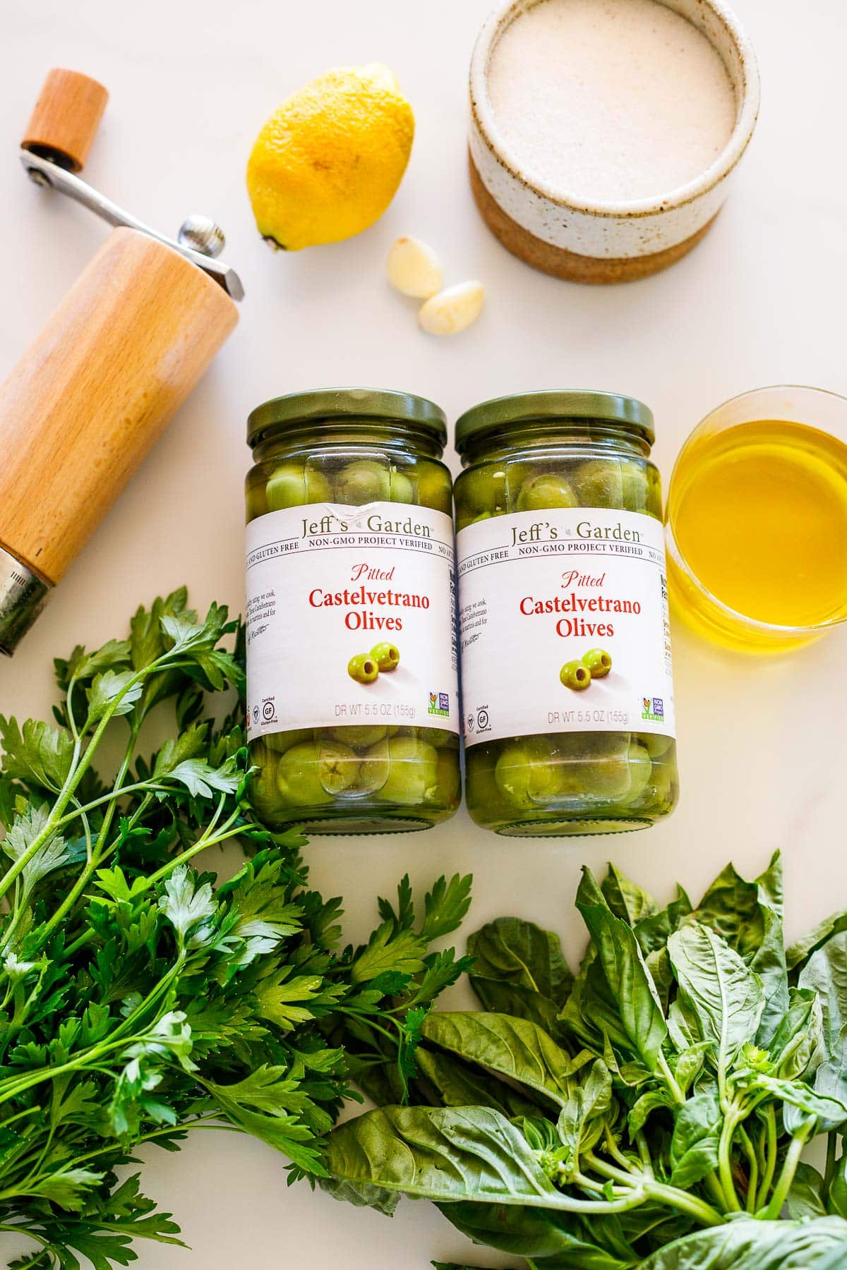 ingredients in green olive tapenade: castelvetrano olives, basil, parsely, olive oil, garlic, lemon. 