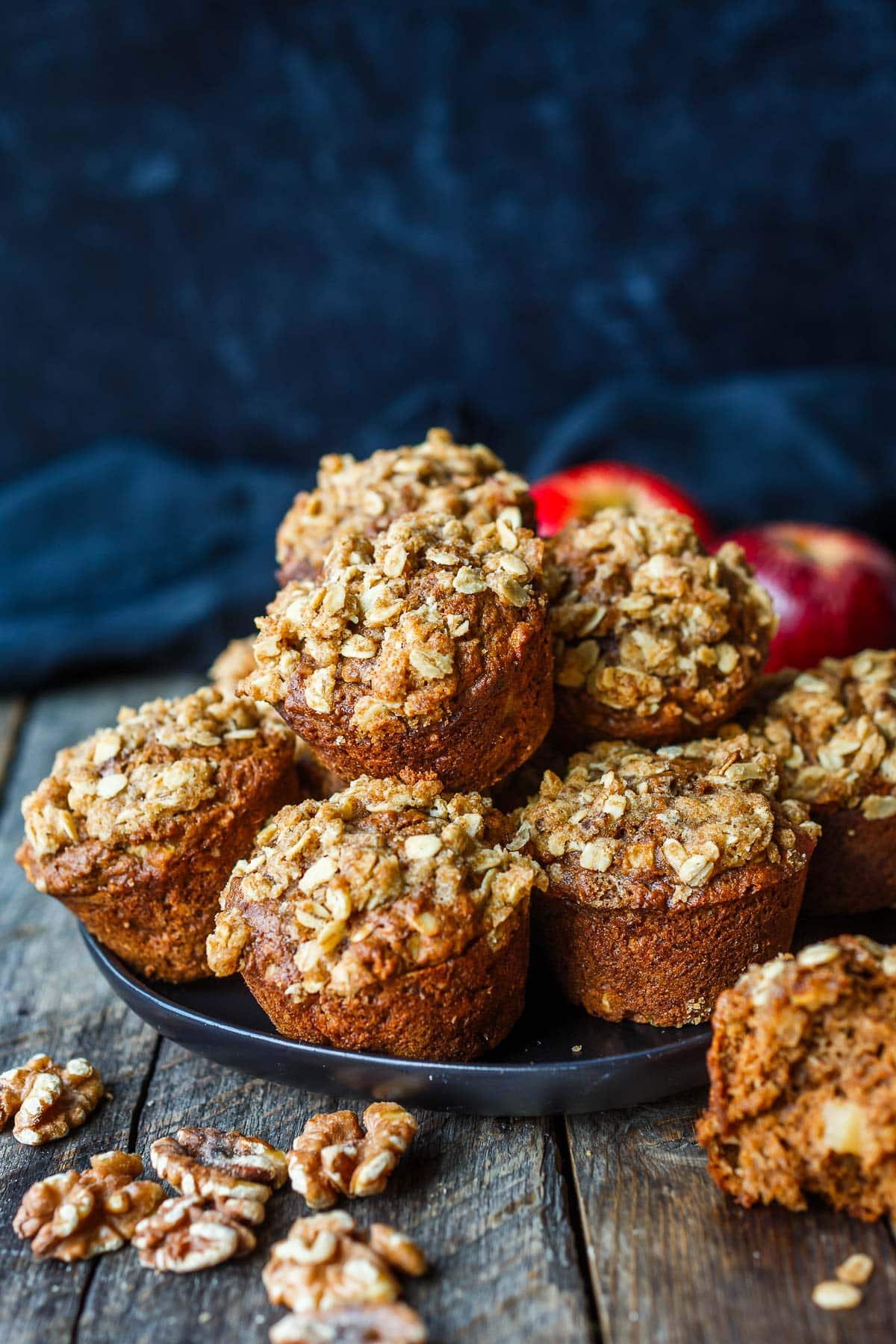 plate of apple oat muffins with crumble topping stacked.