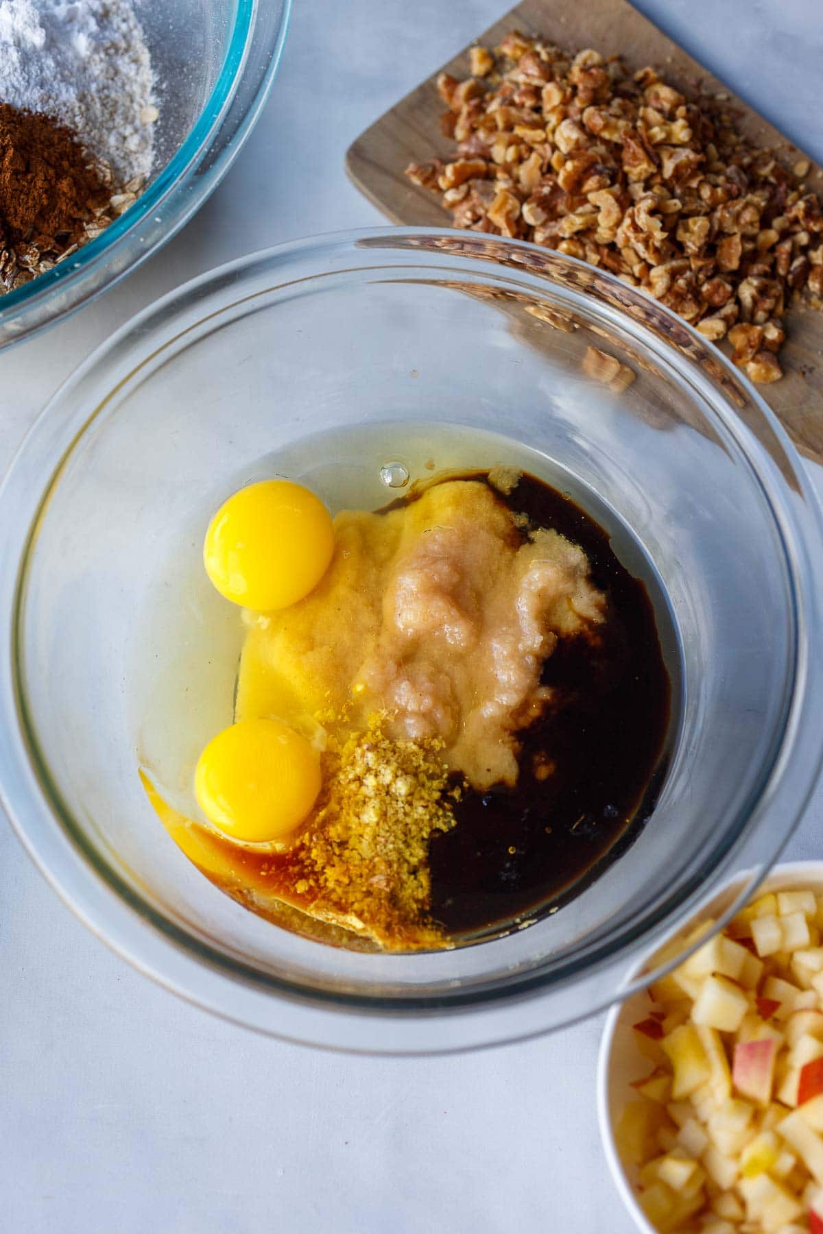 medium glass bowl with wet ingredients - eggs, apple sauce, molasses, vanilla. 