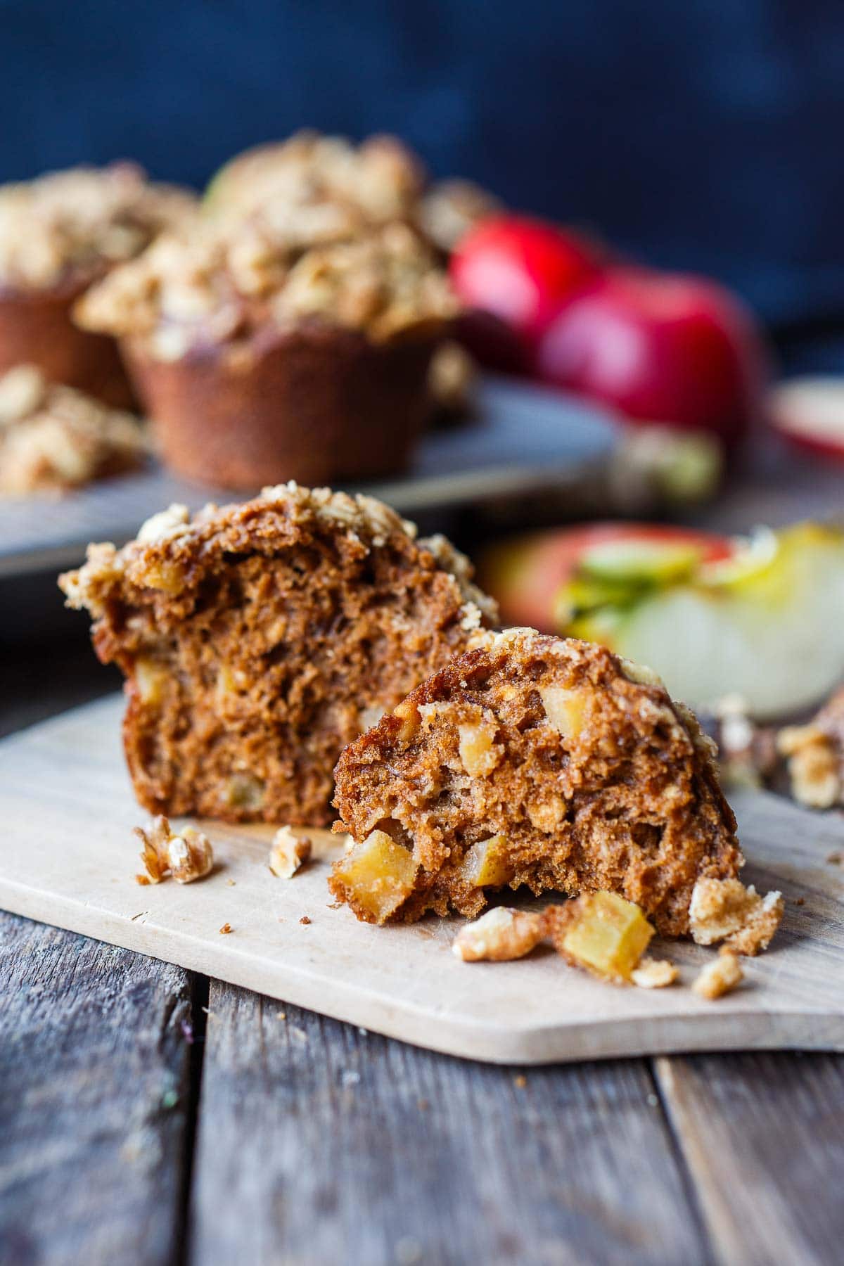 apple oat muffin sliced in half to show moist interior. 