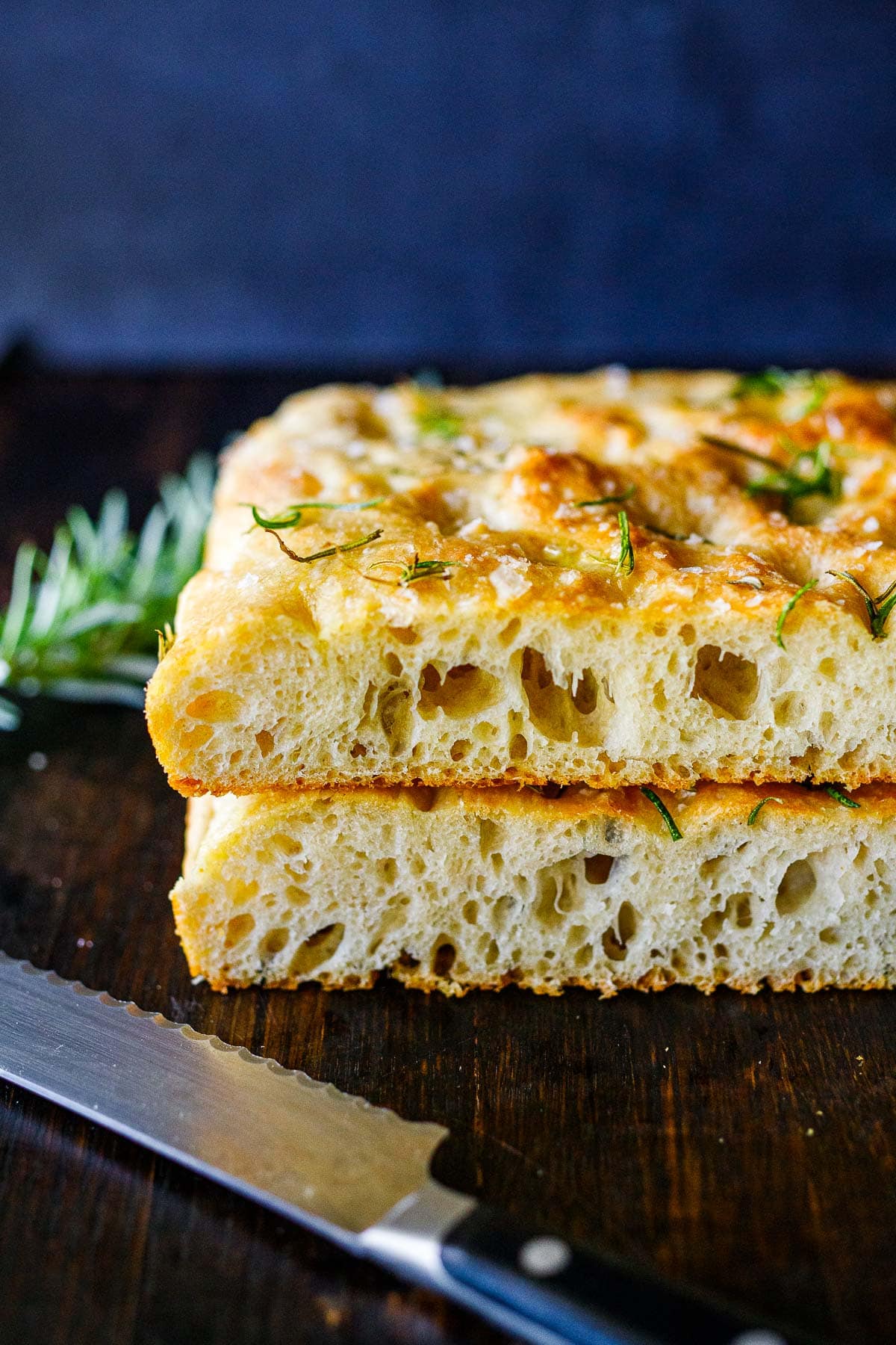Focaccia bread stacked on a cutting board.