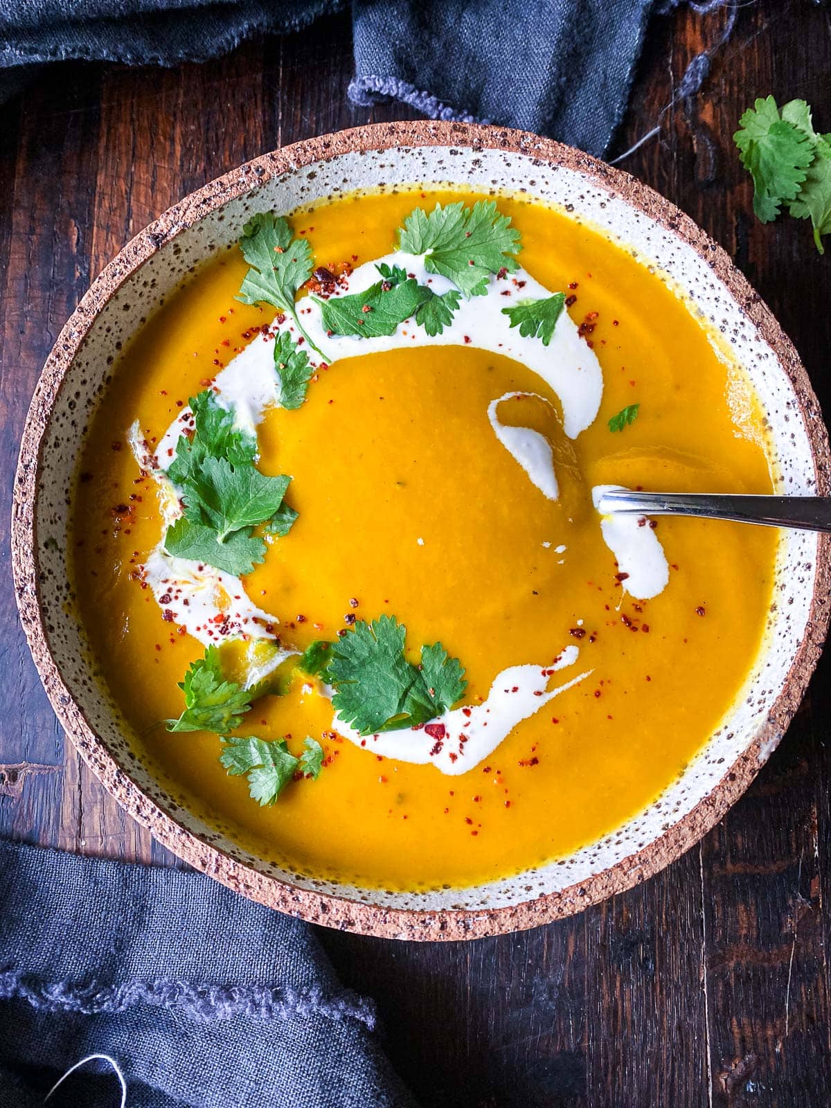 My chef's perfected recipe for glowing carrot and ginger soup is creamy and earthy, enhanced with turmeric.  Vegan and gluten-free in just 30 minutes!