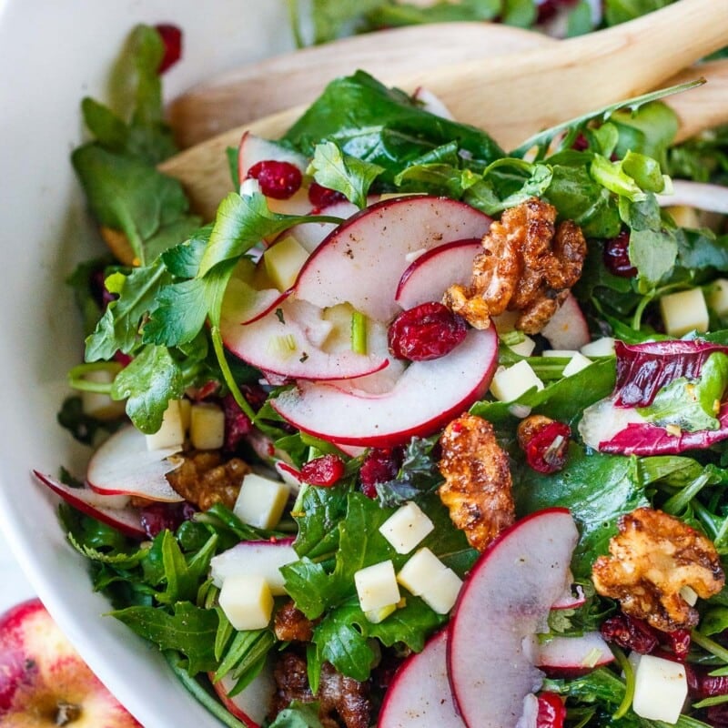 This Apple Cheddar Salad is simple and refreshing! Fresh greens, crisp apples, and sharp cheddar combine perfectly with crunchy cinnamon walnuts, dressed with a flavorful citrus vinaigrette.