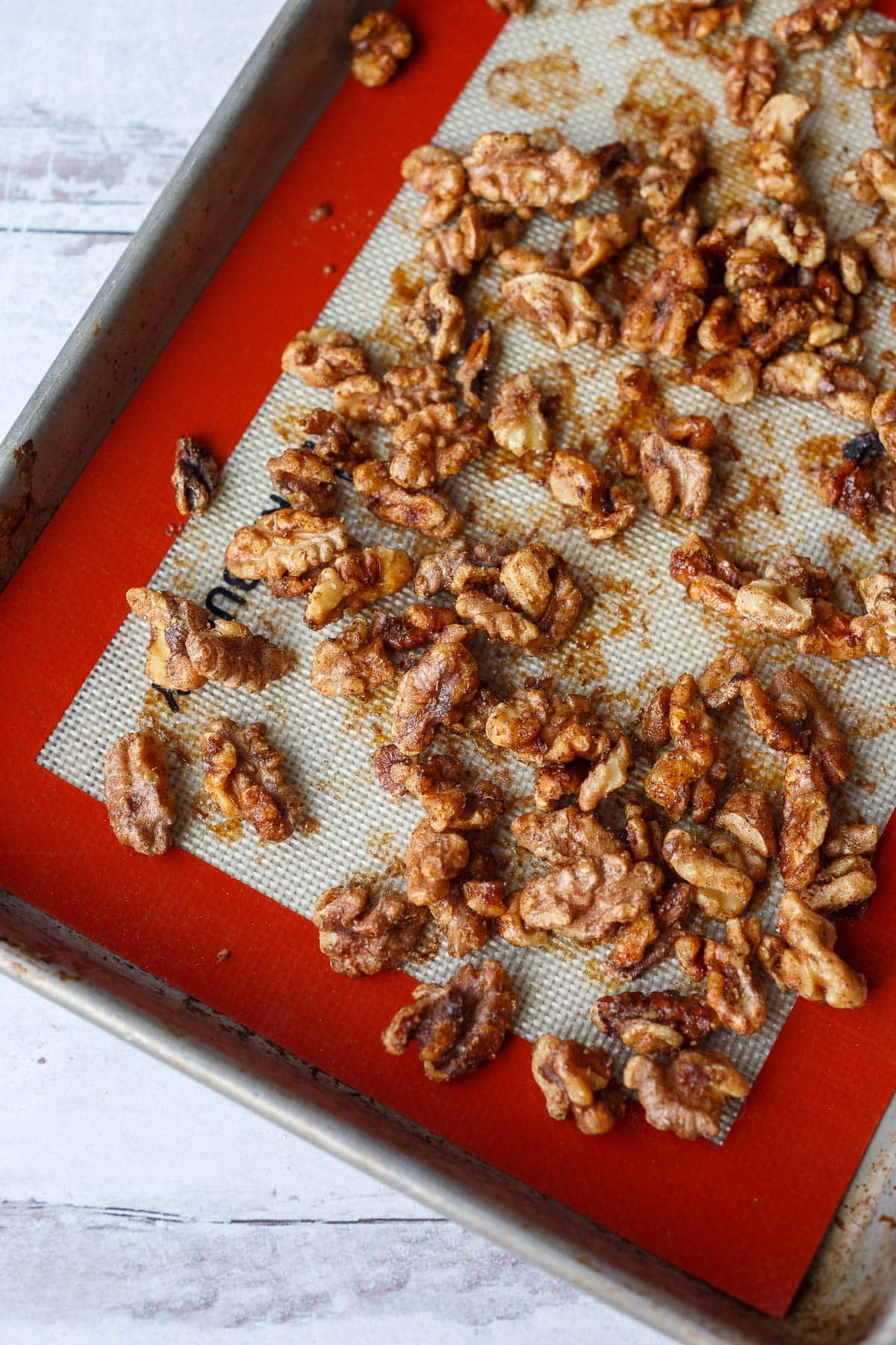 cinnamon walnuts on silpat lined baking sheet.