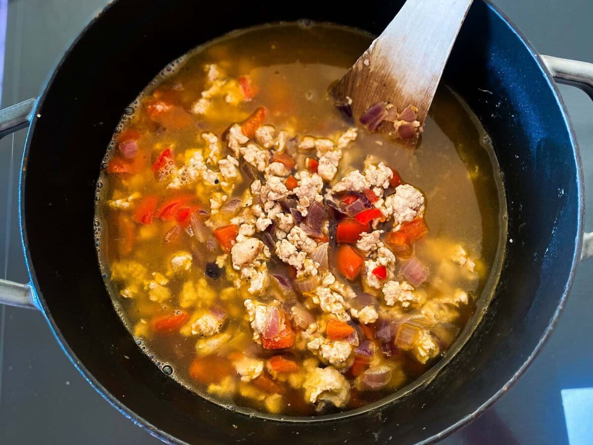 pot with turkey and veggies and broth. 