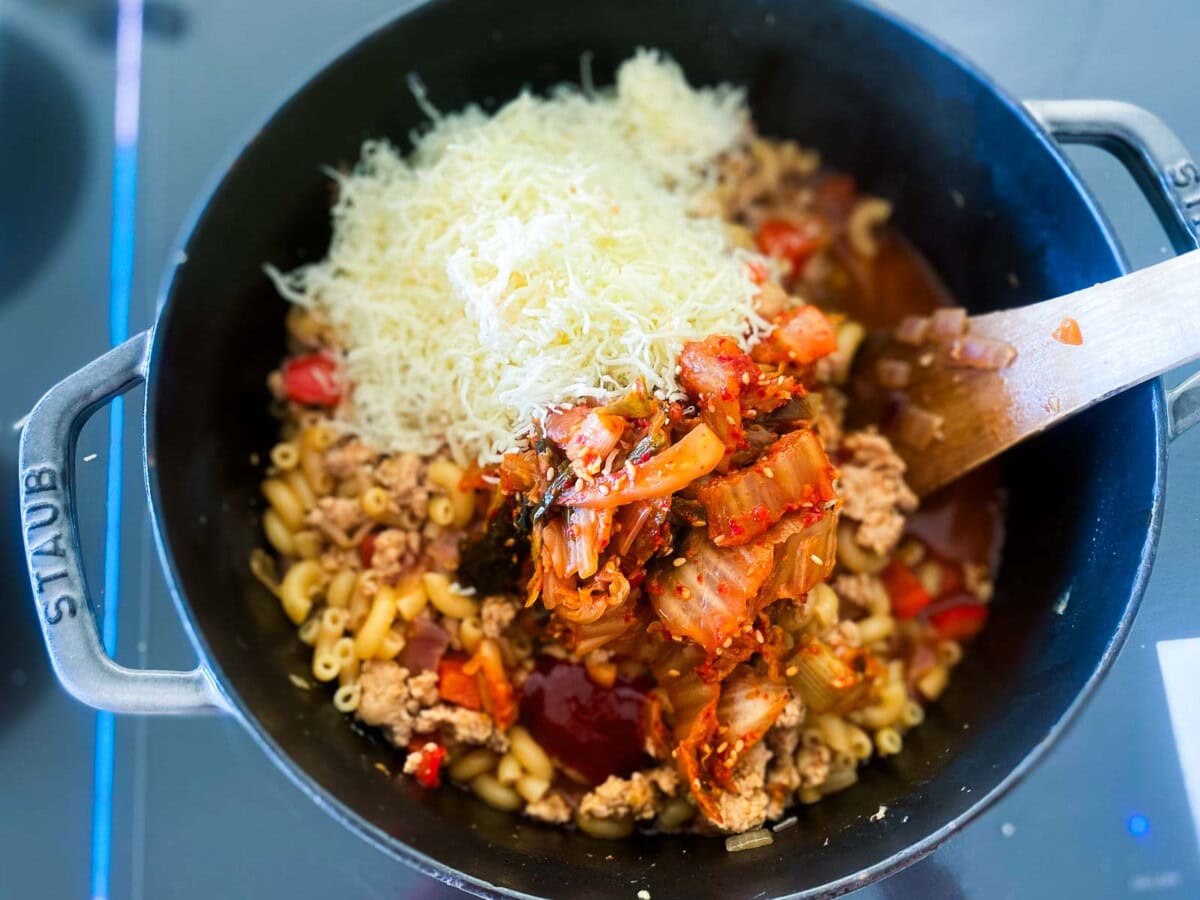 shredded cheddar cheese and kimchi added to large pot with macaroni and ground turkey and veggies. 