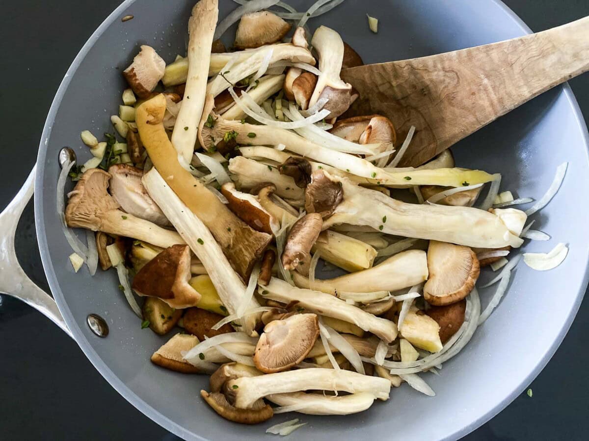 mixed mushrooms and onions in skillet.