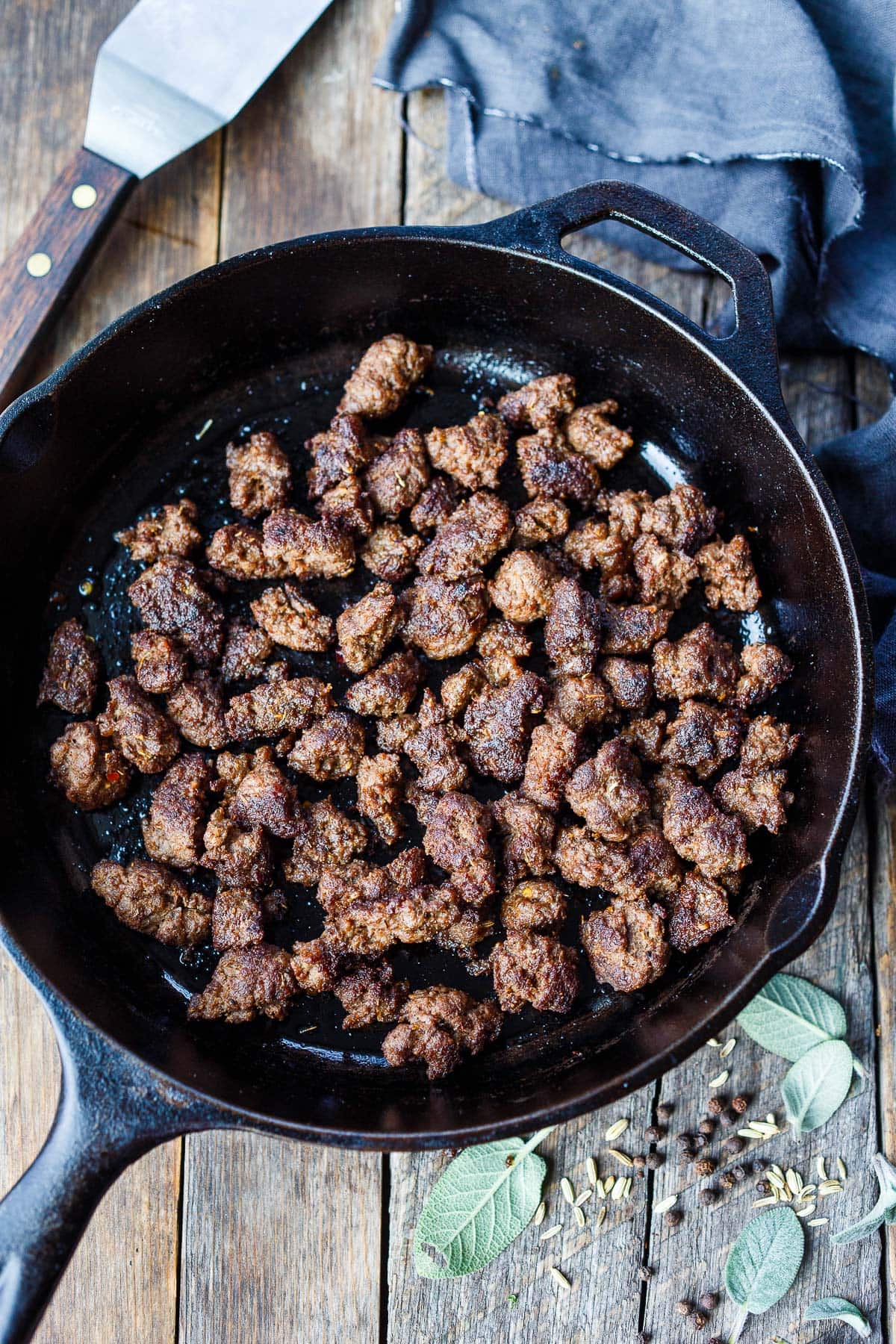 crumbled homemade Italian sausage in cast iron skillet. 