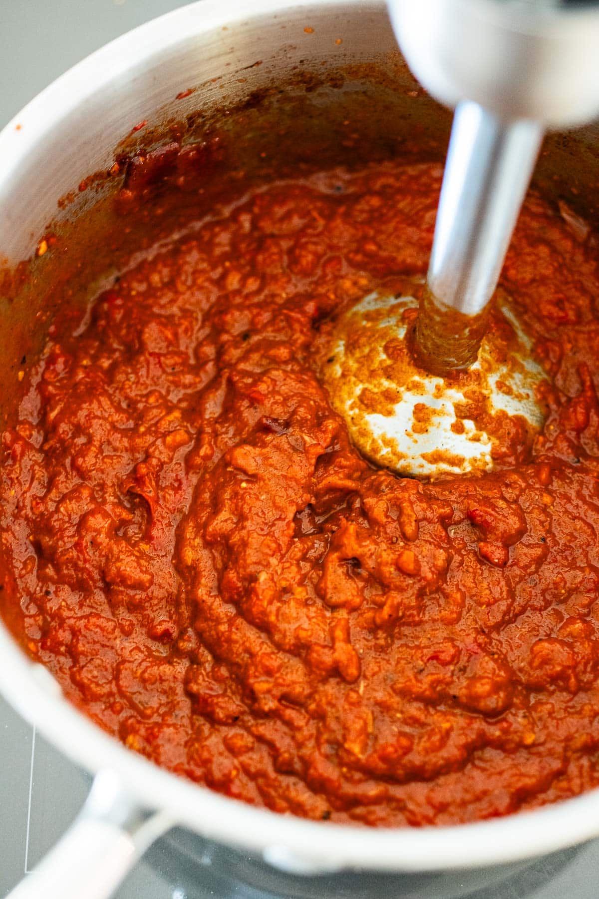 immersion blender in pot blending homemade ketchup.