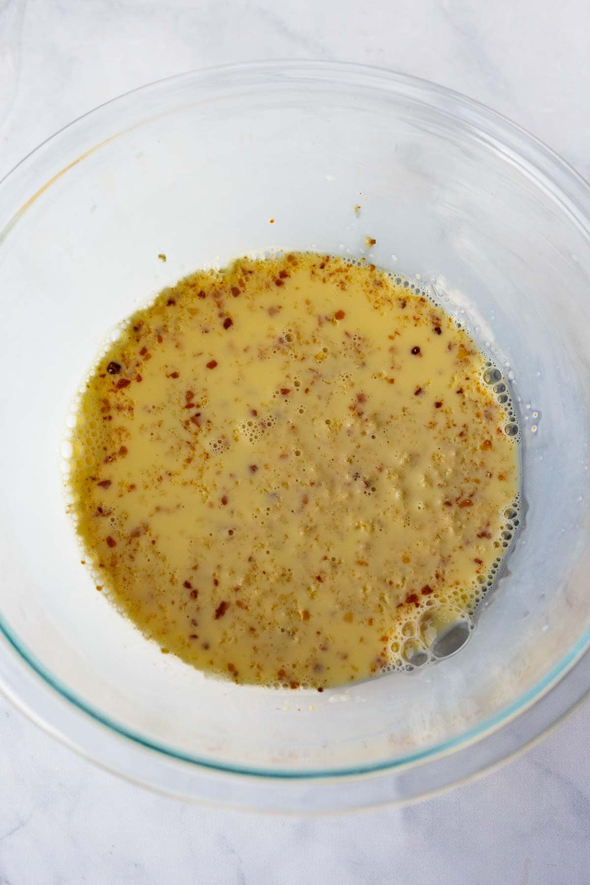 breadcrumbs soaking in glass mixing bowl. 
