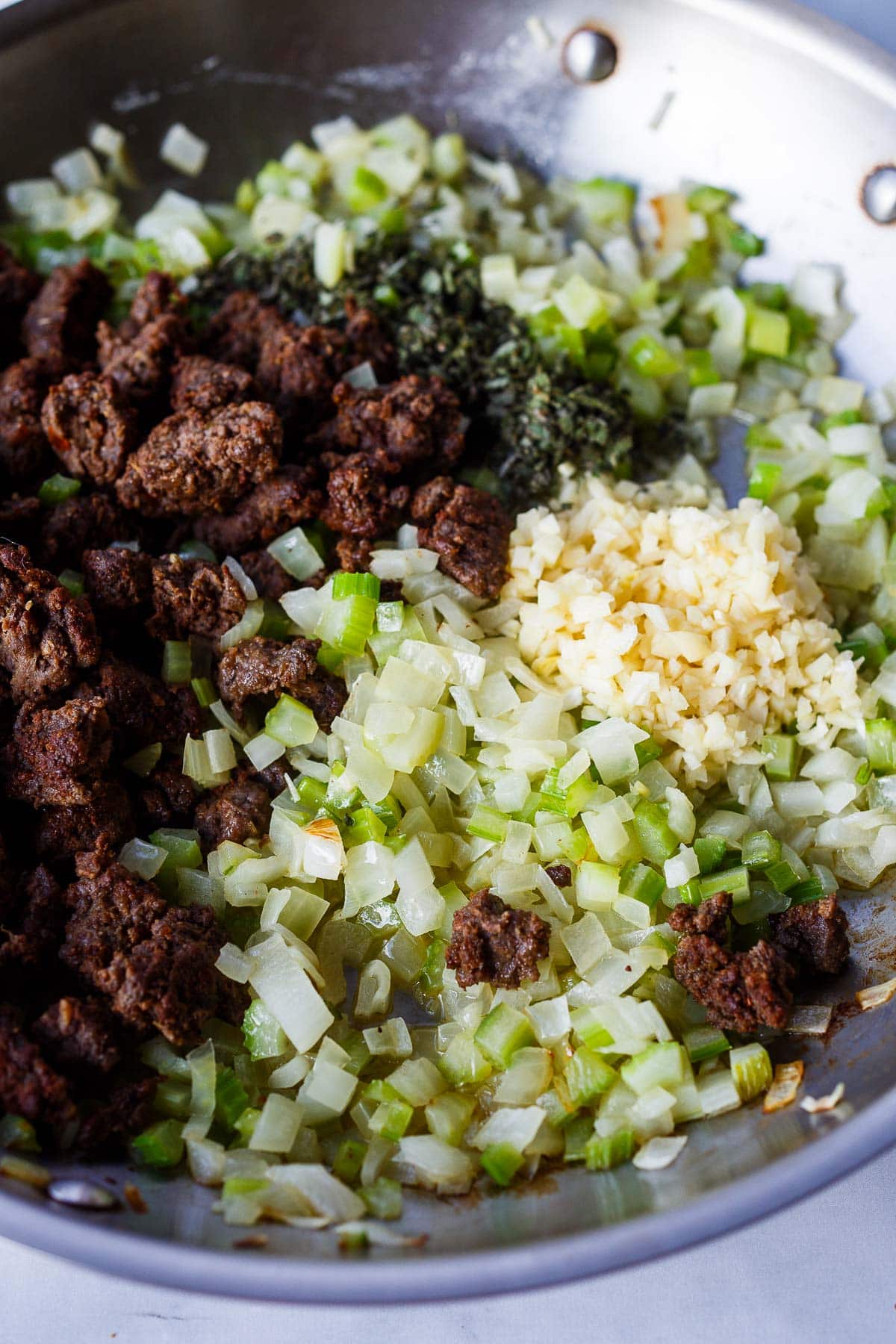Celery, onions, butter, garlic, and sausage in a saute pan.