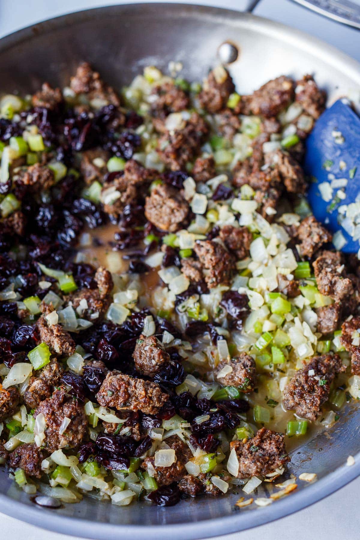 Celery, onions, butter, garlic, and sausage, dried cherries, and wine in a saute pan.