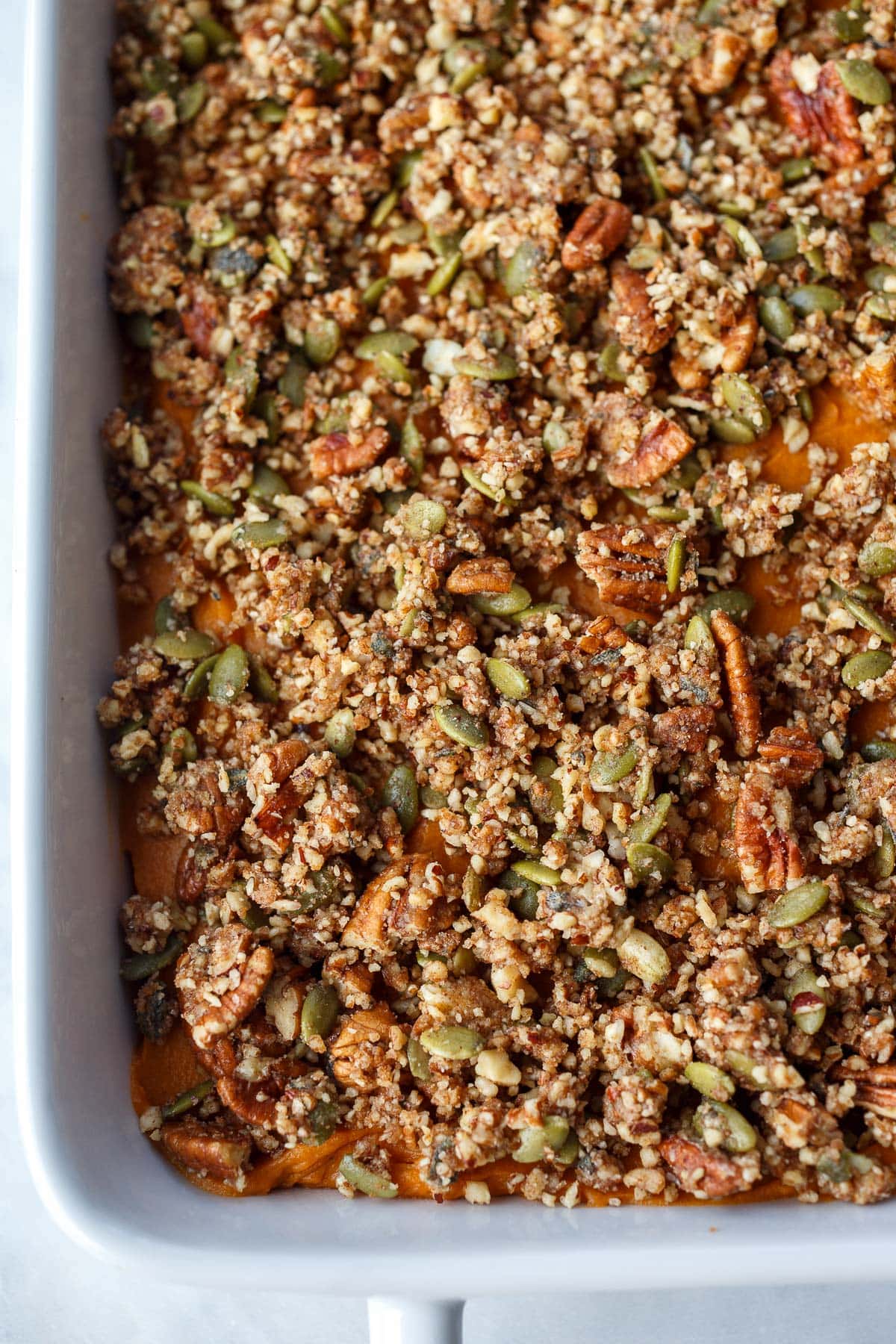 sweet potato casserole unbaked with pecan crumble topping.