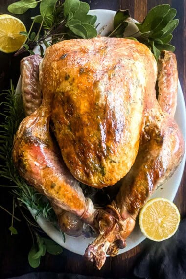 This Roast Turkey recipe is made with fresh herb butter infused with garlic and lemon zest, a simple, no-fuss Martha Stewart recipe that turns out tender and delicious every time!
