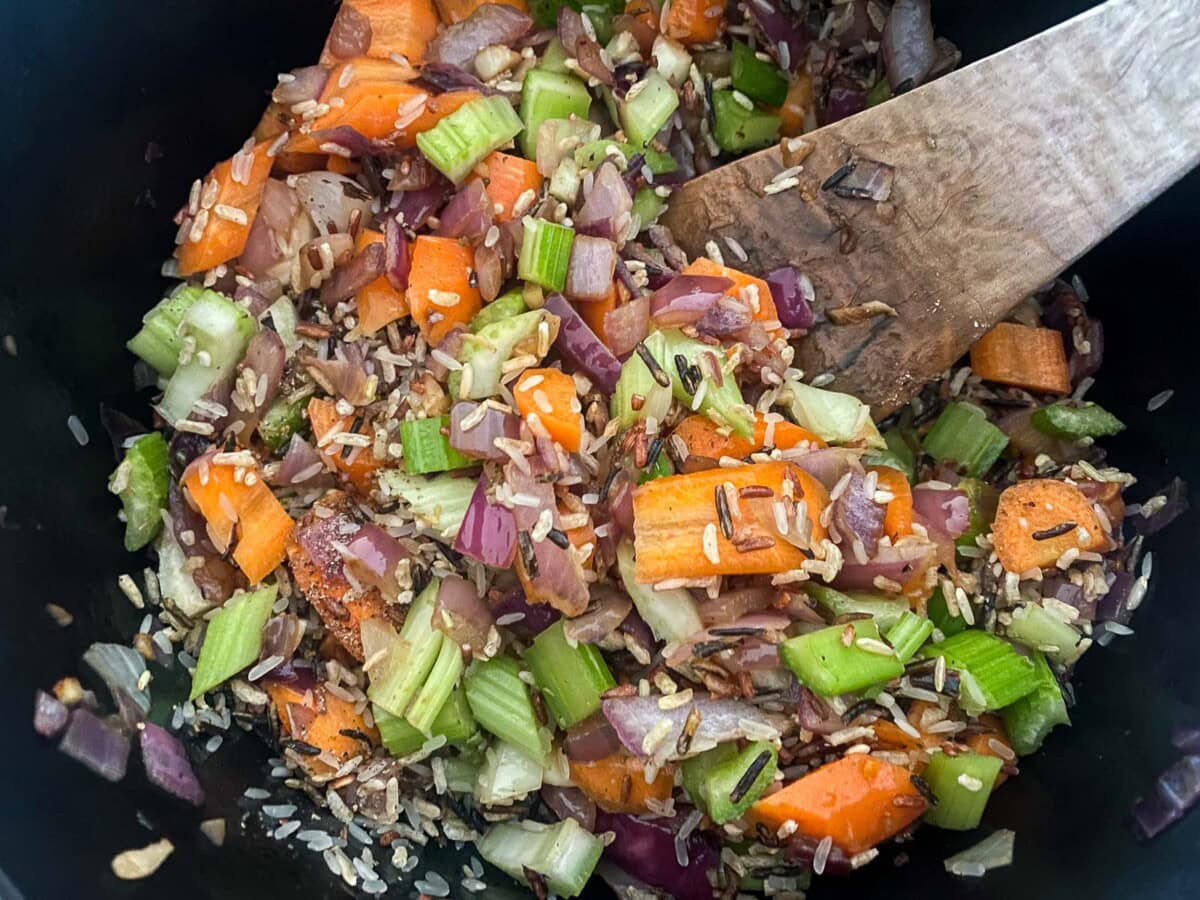 large pot with sautéed veggies and wild rice.