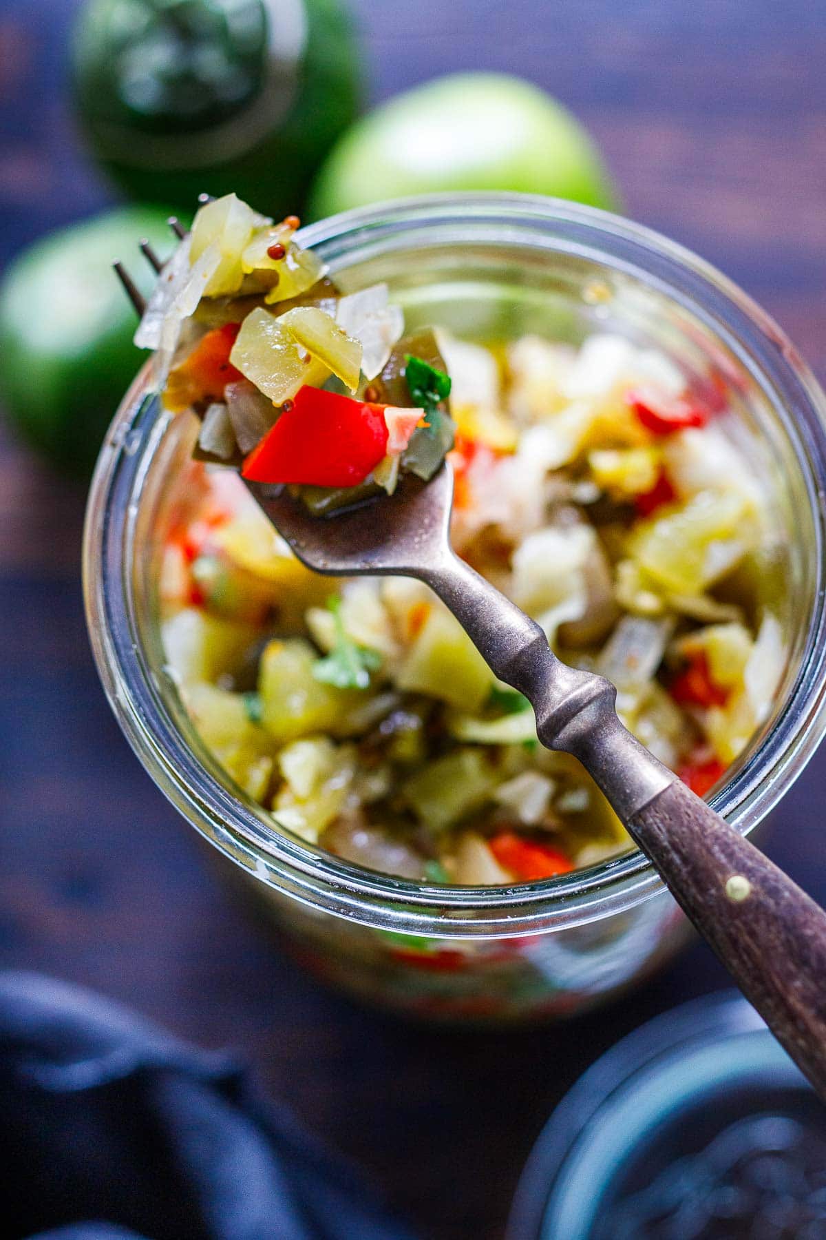 top of jar filled with chow chow with fork holding up the relish.