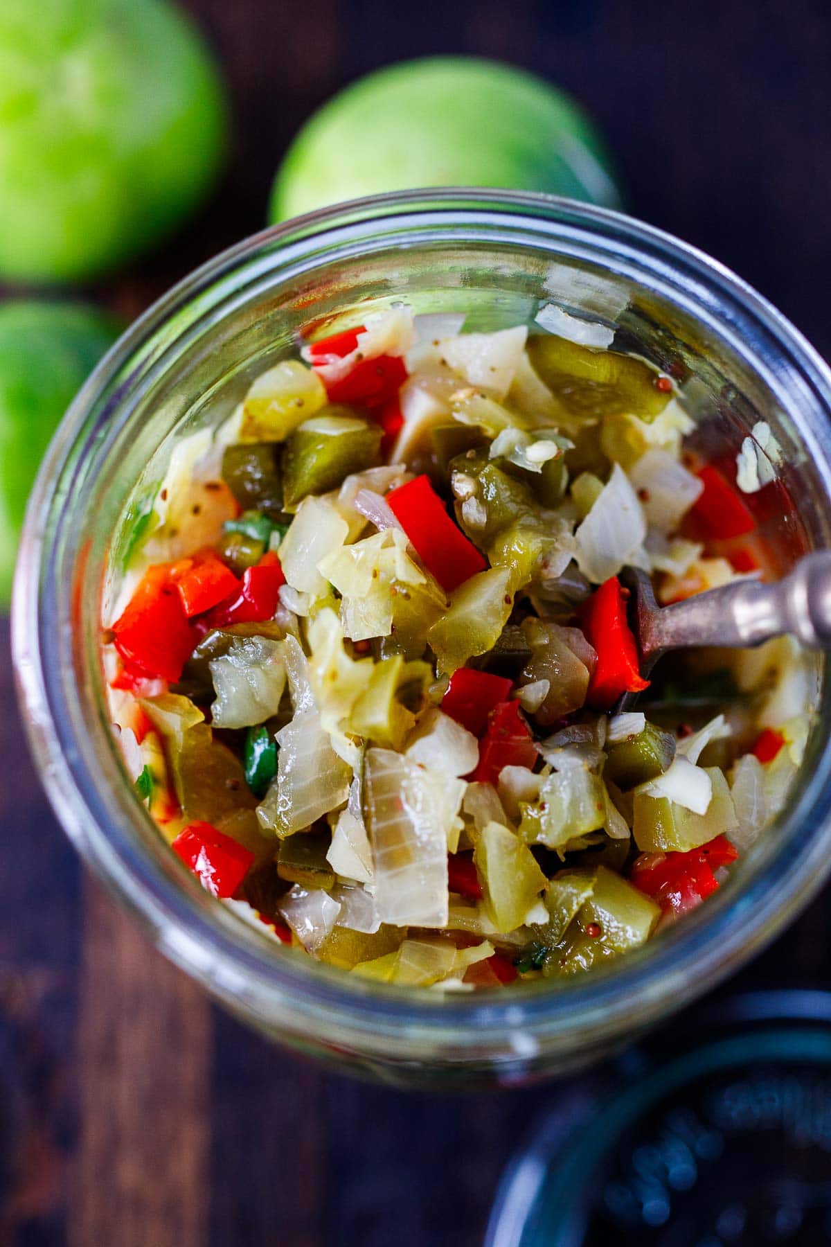 top view of jar of chow chow with fork in jar. 